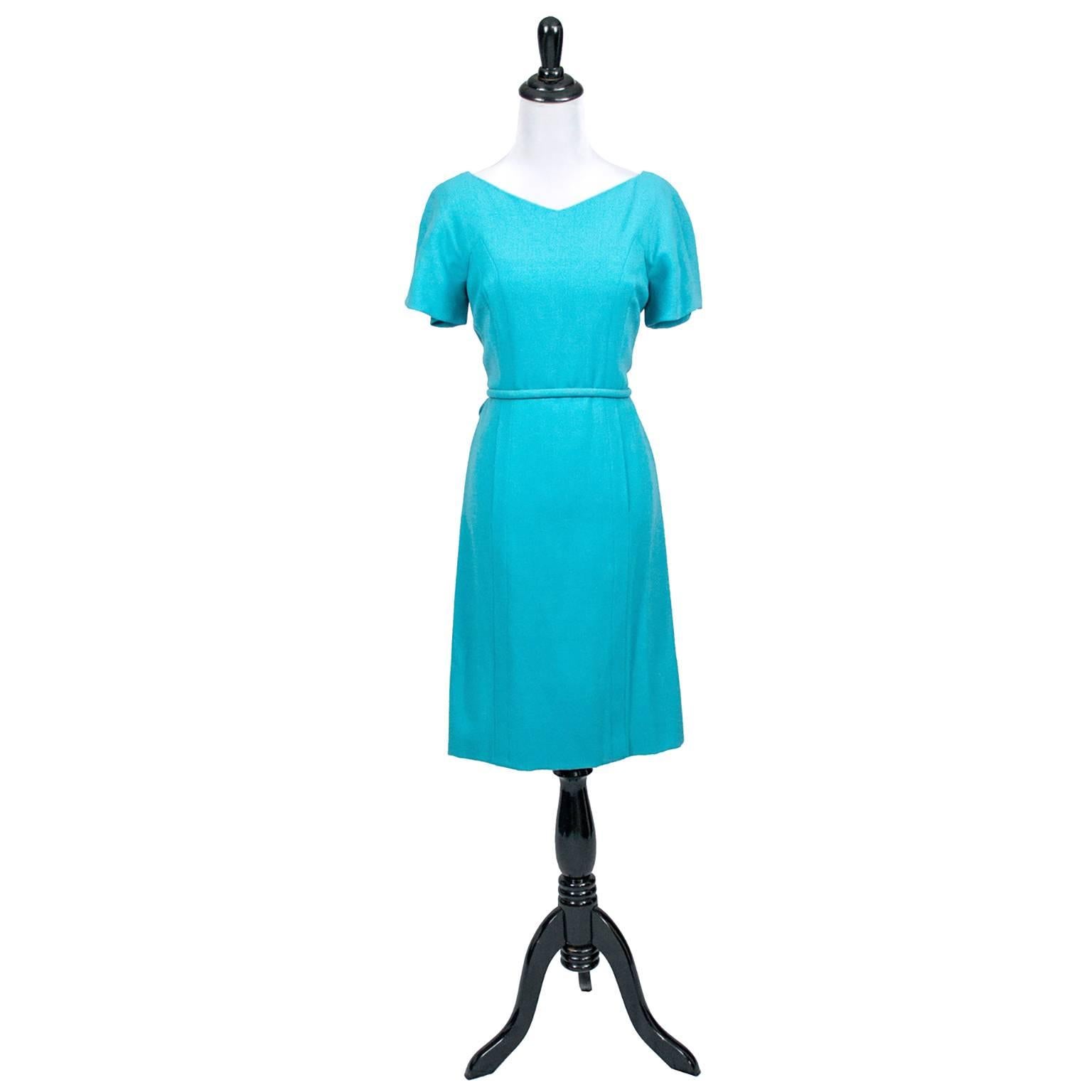 This classic, mint condition vintage dress was designed by Pauline Trigere, and purchased at the high end fashion boutique John Doyle Bishop in Seattle in the 1960s.  This sophisticated blue wool crepe dress is cinched at the waist with a great