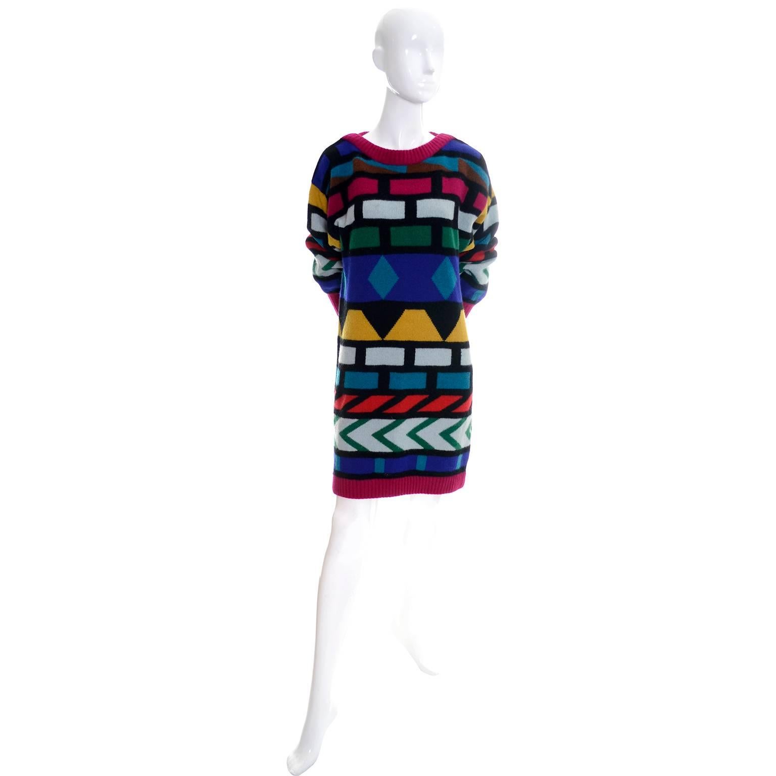 This is a great tunic style vintage sweater dress from Krizia from the 1980's.  The dress has drop shoulders and is made of Angora, wool, and nylon in shades of red, teal, yellow, pale gray, blue, green, black and raspberry.  You can wear it as a