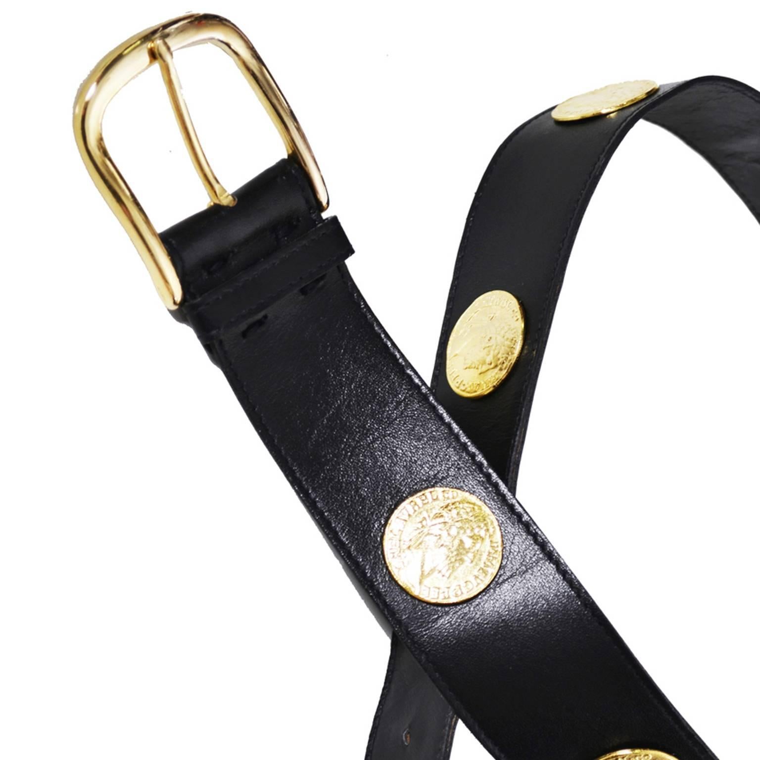 This is a wonderful vintage black leather belt with gold coins from Yves Saint Laurent.  This 1980's vintage YSL belt measures 1 and 3/4 inches wide and fits sizes 29, 30 and 31 inches.  The back of the belt is stamped with Medium Yves Saint Laurent