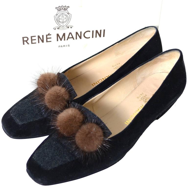 These late 80s or early 90s vintage Rene Mancini loafers have a black velvet body and wool toes.  These great vintage shoes are embellished with mink pom poms and have 1