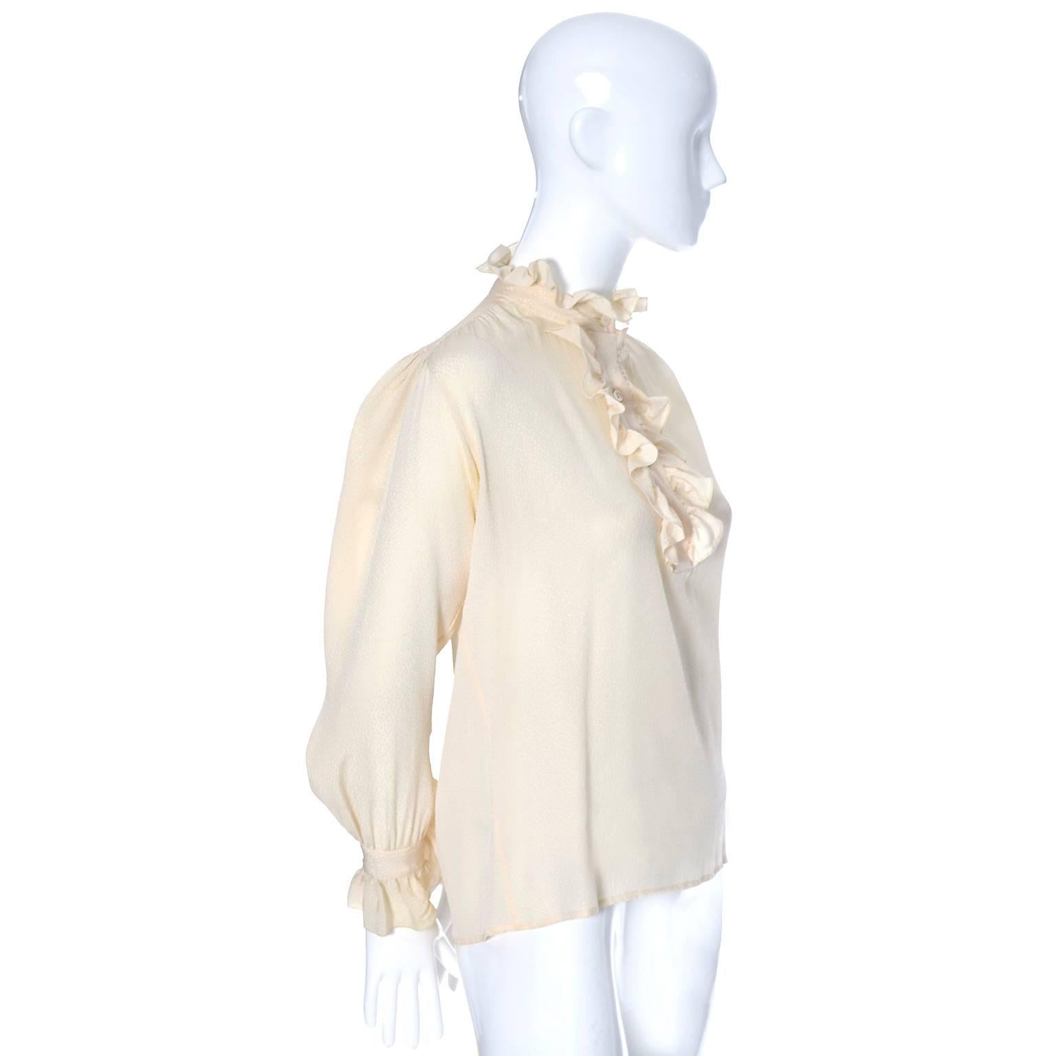 This is a pretty vintage silk blouse from Yves Saint Laurent.  This vintage blouse has the YSL Rive Gauche label and was made in France in the 1970's.  There is a pretty ruffle at the collar, on the cuffs, and around the buttons on the bodice. The