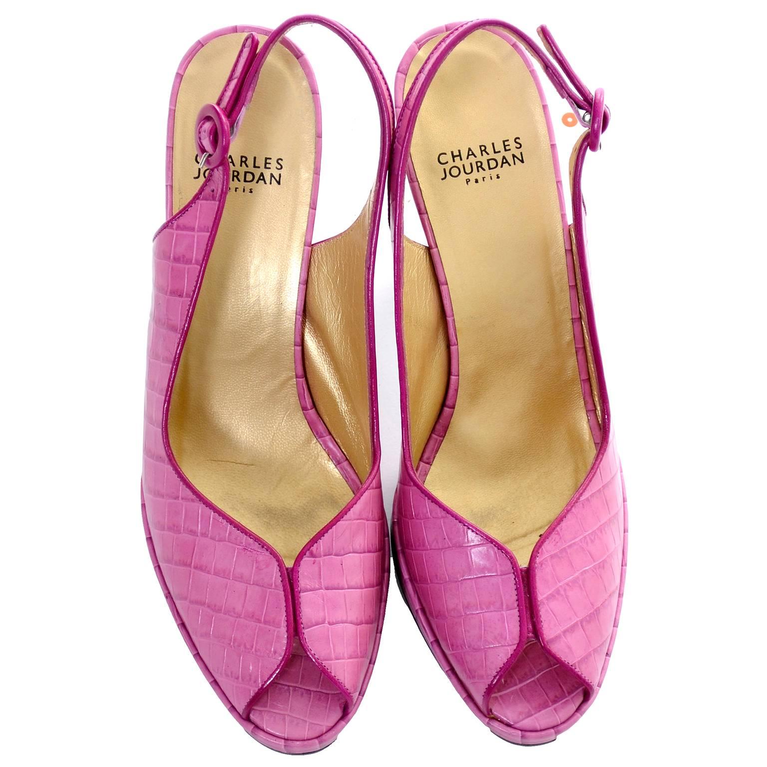 These Charles Jourdan peep toe shoes are in almost new condition and are labeled a size 9.  They are made of a a purplish pink alligator embossed leather and have 4 inch heels.  The shoes are 3 inches wide at the widest part of the outside of the