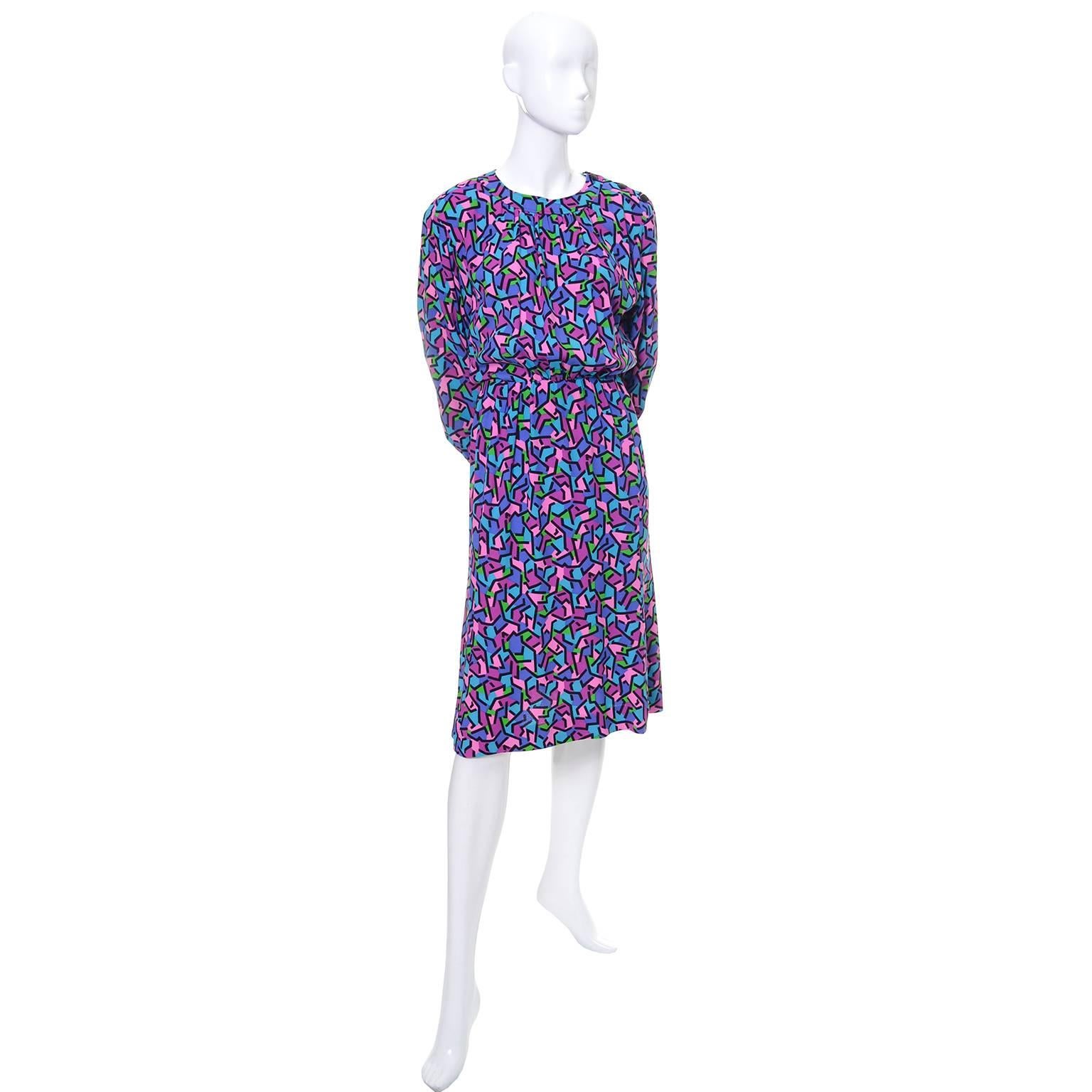 This beautiful abstract multi colored printed silk YSL vintage dress was made in France in the late 1970's or early 1980's.   The dress is in as new condition and has buttons on the top of the left shoulder and a side zipper.  This dress is labeled