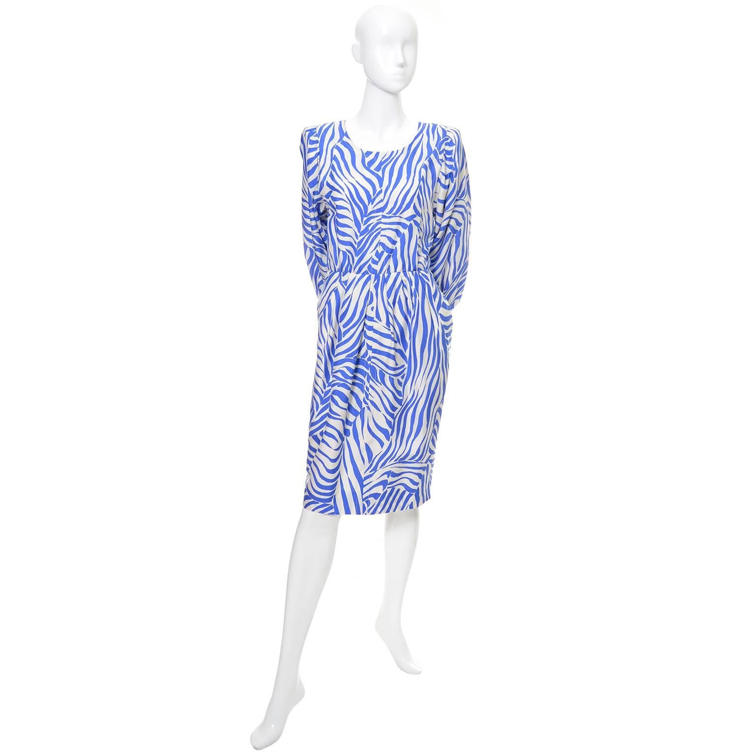 This vintage abstract zebra print silk YSL dress was made in France in the 1980's. The dress is fully lined and has shoulder pads and both back buttons and a back zipper.  Labeled a size 36, (approximately a US size 4), the dress is in excellent