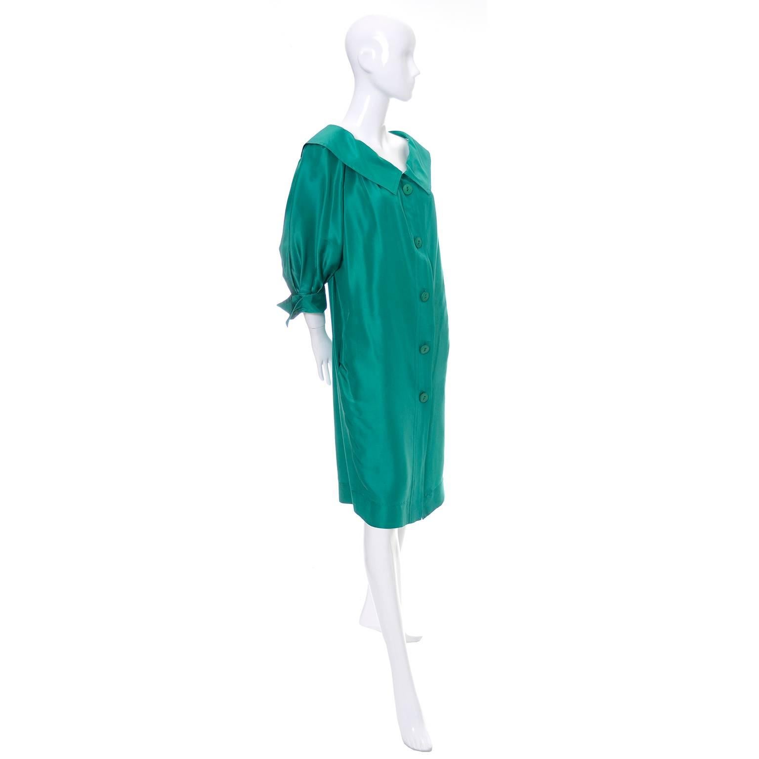 This is a late 1970's vintage YSL green silk dress with buttons up the front.  The dress has side pockets, pretty detailed cuffs on the 3/4 length puffed sleeves, and is labeled a size 38 (Approximately a US size 6). This Yves Saint Laurent dress