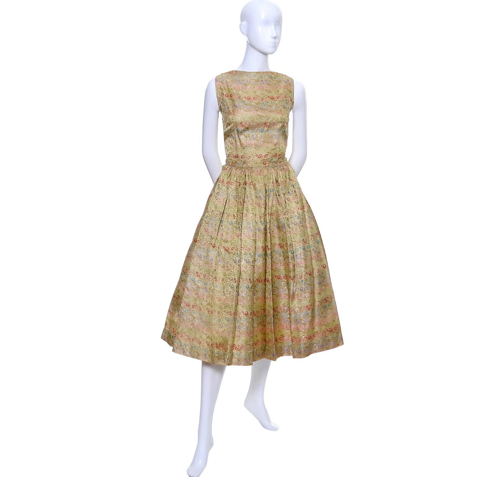 This is a rare, late 1950's early Nelly de Grab vintage brocade 2 piece gold dress with tiny multi colored flowers.  She was known for her more casual cotton prints and day dresses, but this is an early example of her more elegant designs. Press
