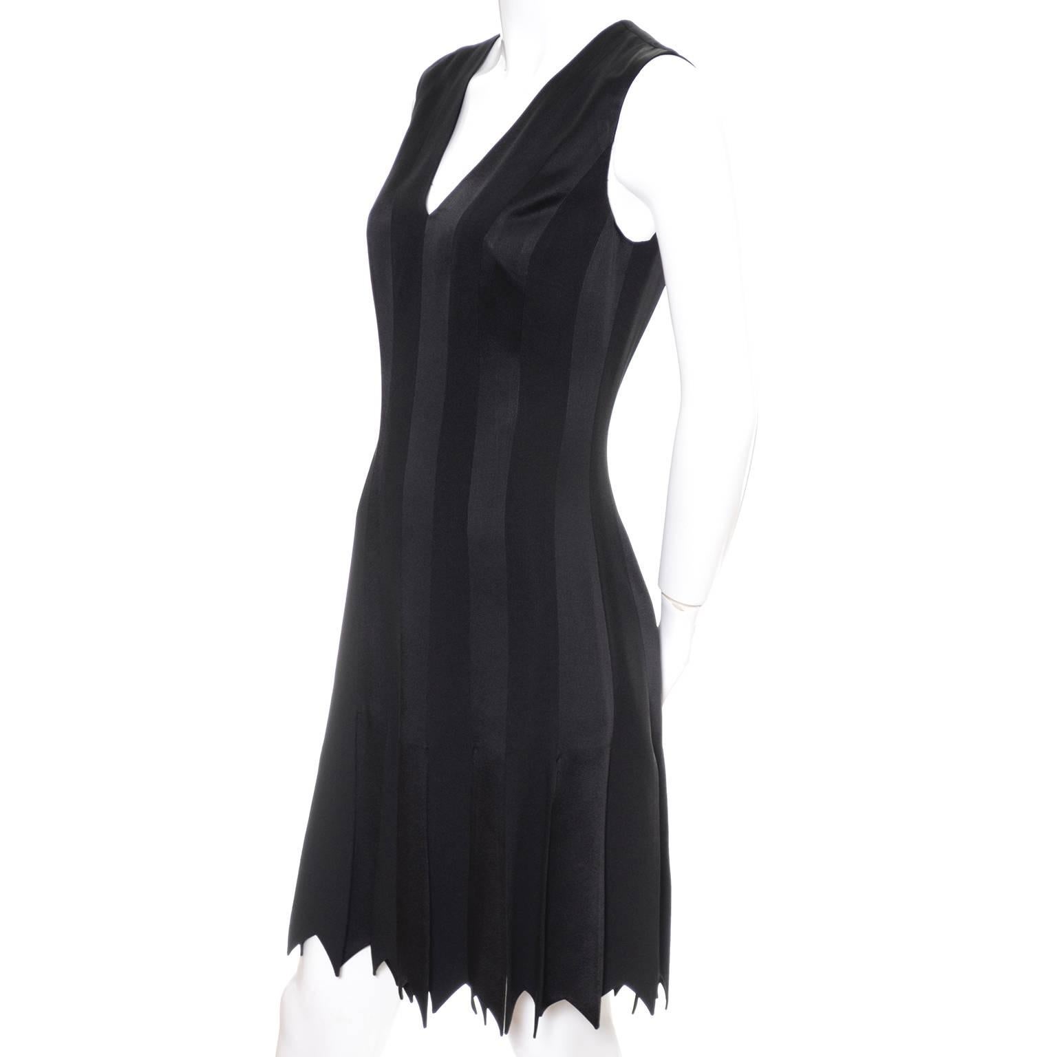 This is a pretty amazing 1990's vintage black dress from Moschino Cheap and Chic. This sleeveless dress has a deep v neck and a back zipper. The hemline is made up of panel strips that resemble wide fringe. I've tried to show these in the