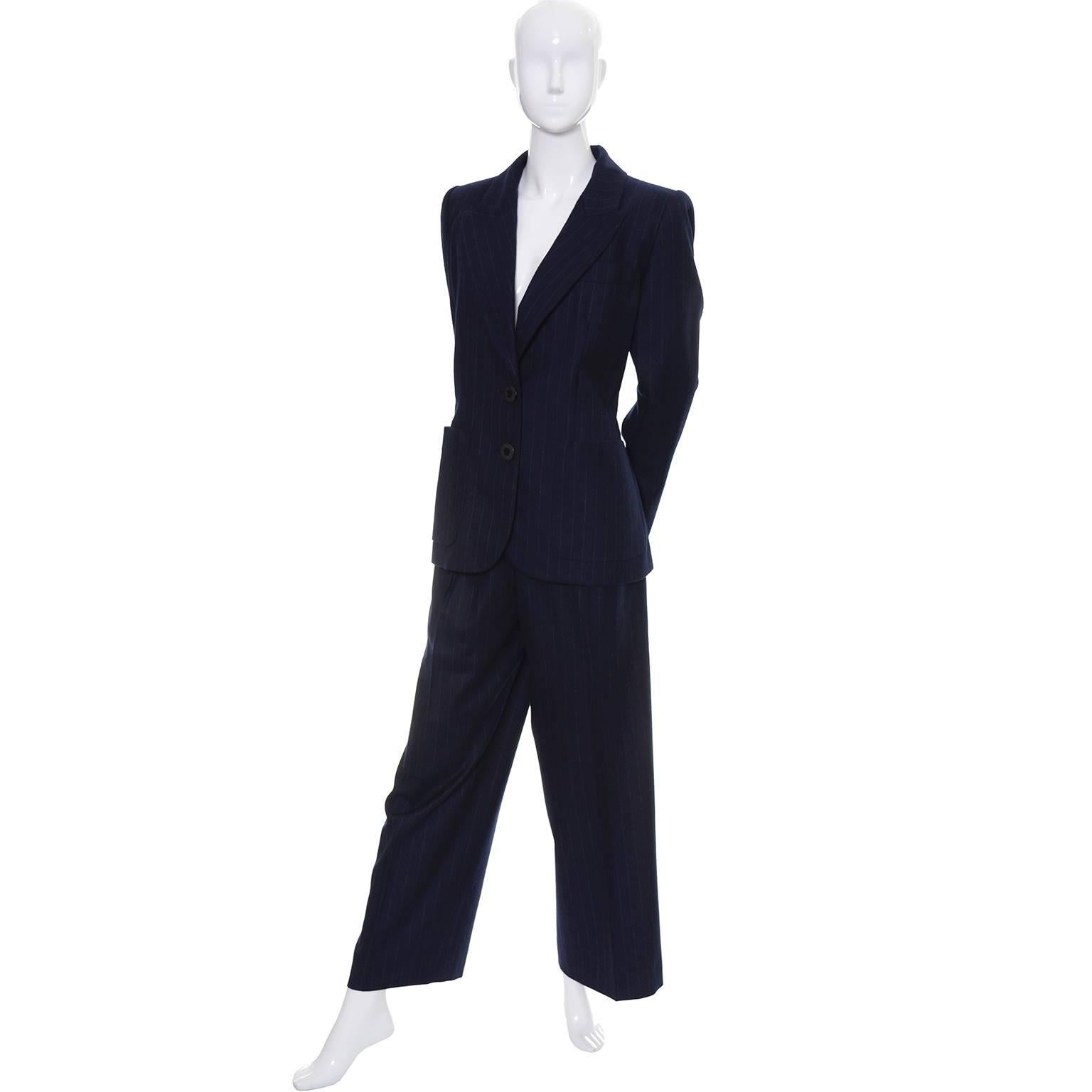 This beautiful midnight navy blue pinstripe pantsuit was designed by Yves Saint Laurent in the late 1980's or early 1990's. We acquired this from an estate of YSL vintage clothing that included Yves Saint Laurent suits, dresses, coats, jackets,