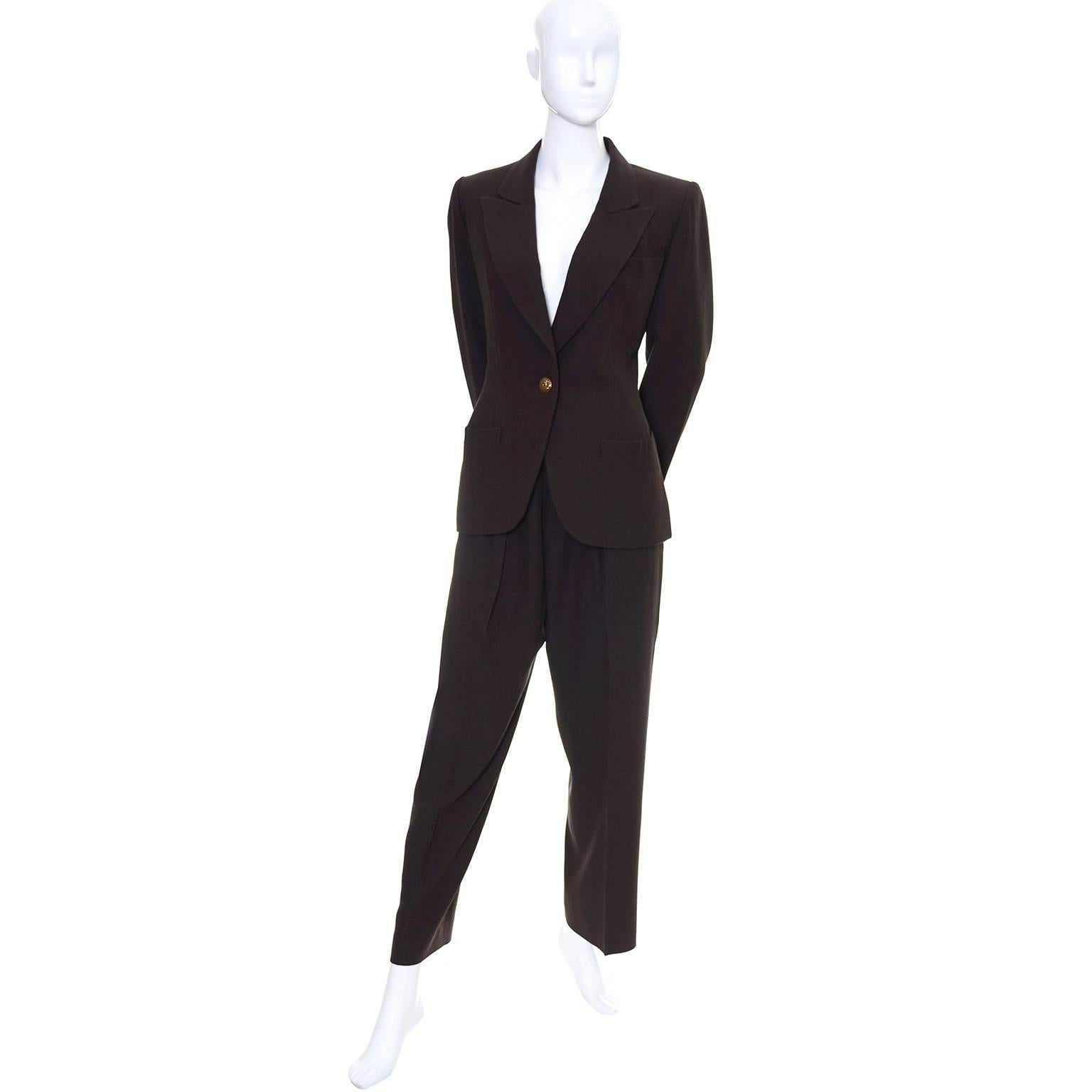 This is an ultra sophisticated, classic vintage pantsuit from Yves Saint Laurent in a finely ribbed chocolate brown wool.  The blazer closes with a single button, has shoulder pads and is lined. The pants have side slit pockets and are high waisted.