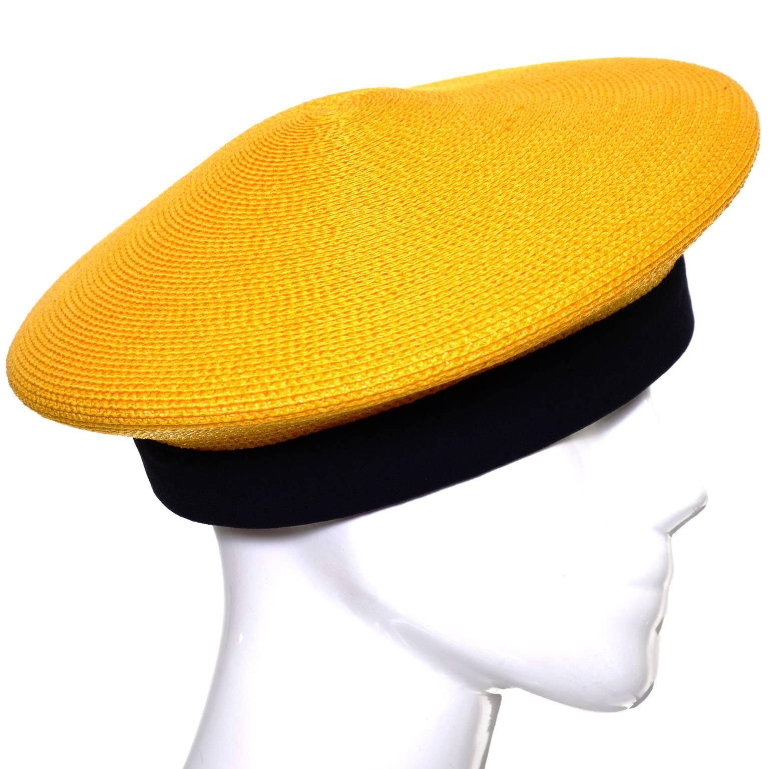 This pretty vintage Donna Karan marigold yellow straw beret has a black silk band and appears to have never been worn! The hat measures 21 and 1/2 inches on the inside in circumference. 