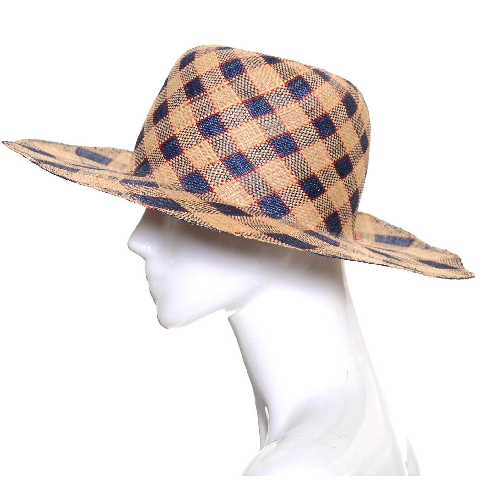 This vintage hat was designed by Therese Ahrens and was purchased at Bullock's Wilshire in the late 1960's.  This straw hat is navy and natural plaid with fine red lines and the shape is a nonagon with 9 squared off edges.  This hat came from an