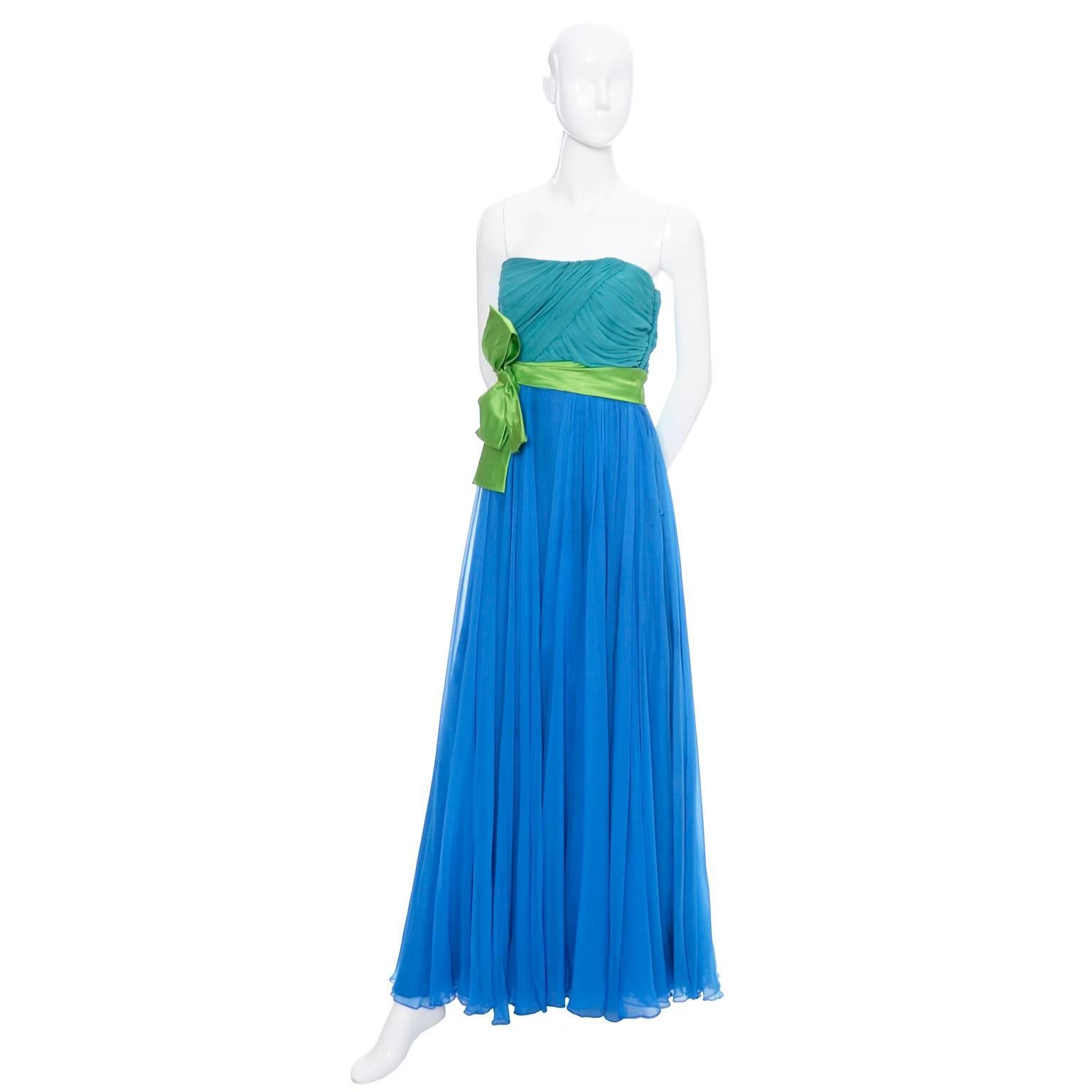 It's almost impossible to find silk chiffon like this anymore!  This is a beautiful vintage 1960's strapless silk chiffon formal dress. This dress has an aqua silk ruched bodice and very full royal blue silk chiffon skirt. The lime green satin sash