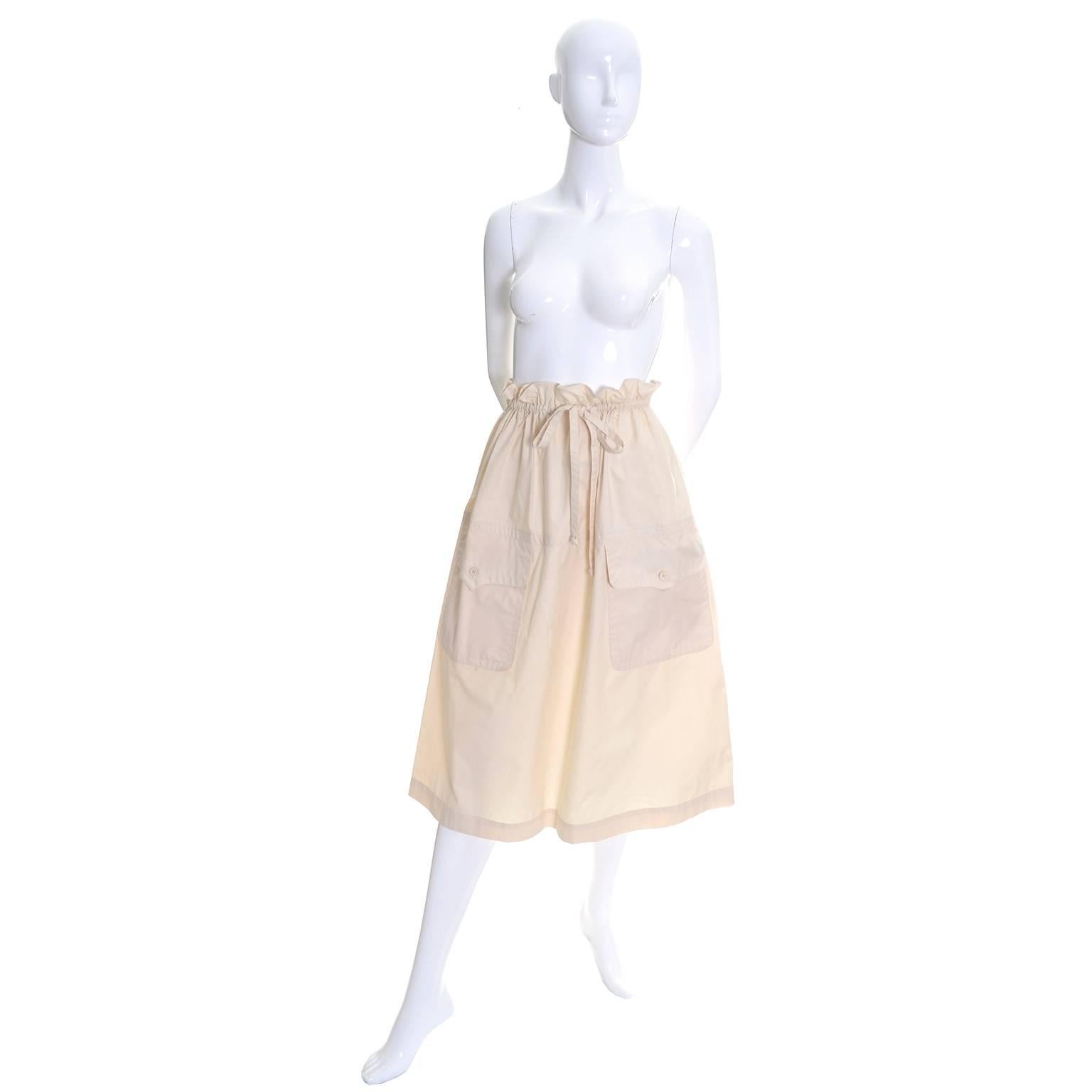 This vintage skirt is from the estate of a woman who bought mainly YSL and Valentino from the 1960's through the early 1980's and barely wore any of her clothing. This medium weight cream cotton skirt is from the 1970's and has a paper bag style