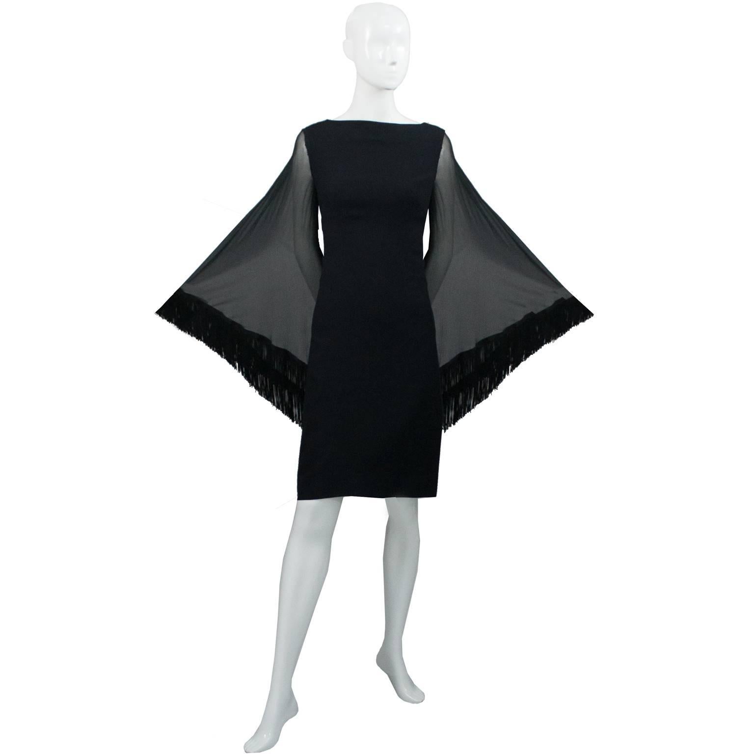This is an exceptional black crepe vintage Lilli Diamond vintage 1970s dress with amazing batwing sleeves. This vintage but modern cocktail dress is in excellent condition and has a back zipper and great fringe on the sheer sleeves.  I would