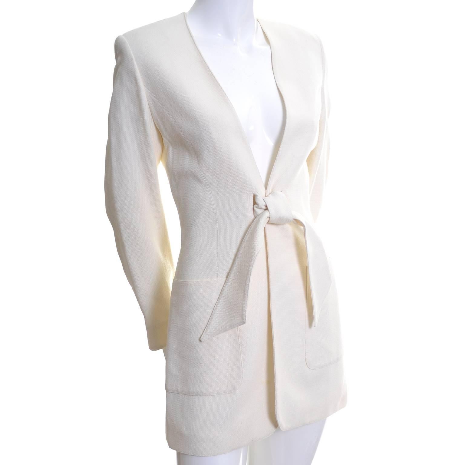 This is a beautiful Claude Montana vintage blazer from the 1980's. The jacket has two slits in the front that are closed with a sash. There are shoulder pads, front pockets, and the blazer is fully lined.  The fabric feels like a silk or silk/linen