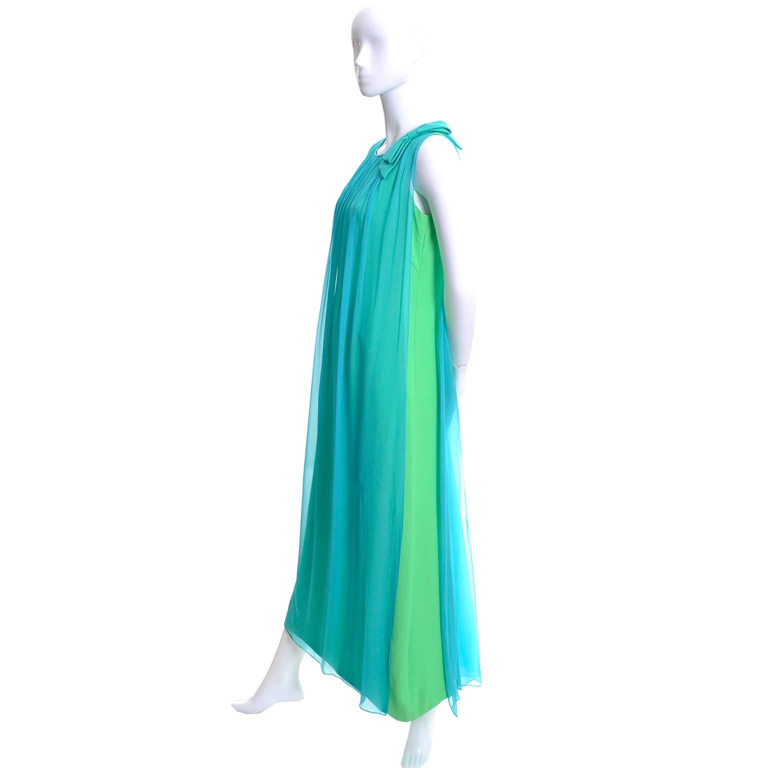This great vintage dress is from the 1960's.  There is a green satin evening gown with an aqua blue silk chiffon overlay with a bow on one of the shoulders.  Beautiful flowing vintage dress that I estimate to be a modern day US size 6/8, but please