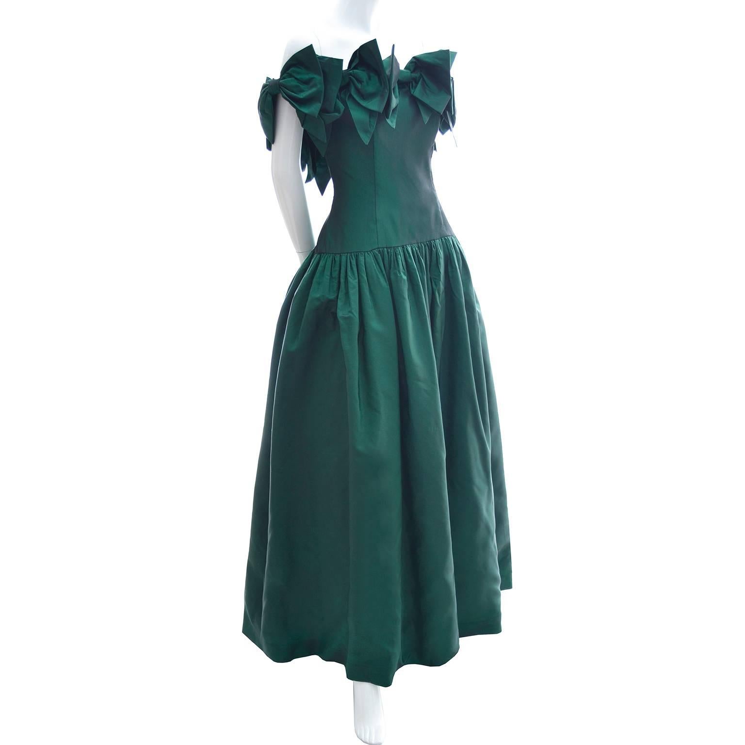 This stunning iridescent green vintage dress was designed by Victor Costa and was purchased at Saks Fifth Avenue in the 1980's. The dress has a back zipper and the semi off shoulder neckline is covered with bows. There is a built in tulle slip and