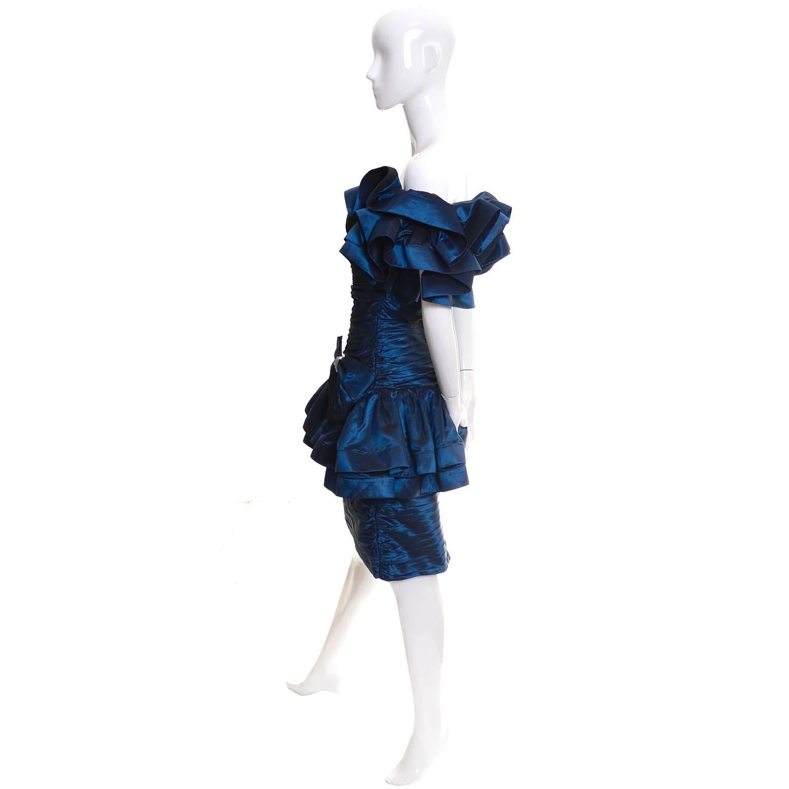 This stunning iridescent blue satin vintage dress from Tadashi Shoji is a show stopper with its off shoulder ruffles and giant bow with rhinestone and bead embellishment.  These vintage Tadashi dresses are so amazing and this one is a great example