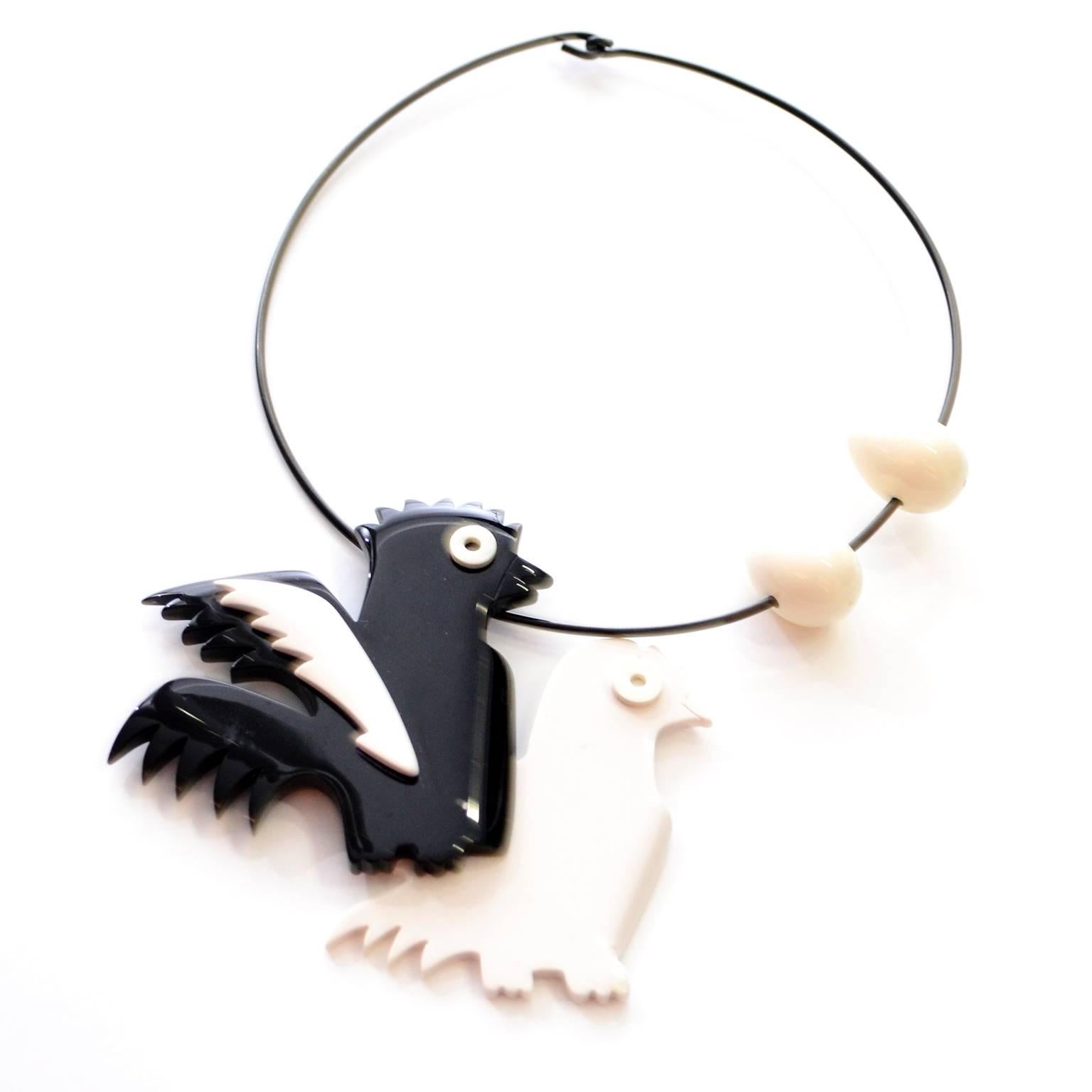 This is a very rare vintage necklace from Isadora Paris. This is a 1980's French Bakelite, or Galalith, choker style necklace with chickens and eggs, which begs the question.. which came first? The white chicken is attached to the black one and
