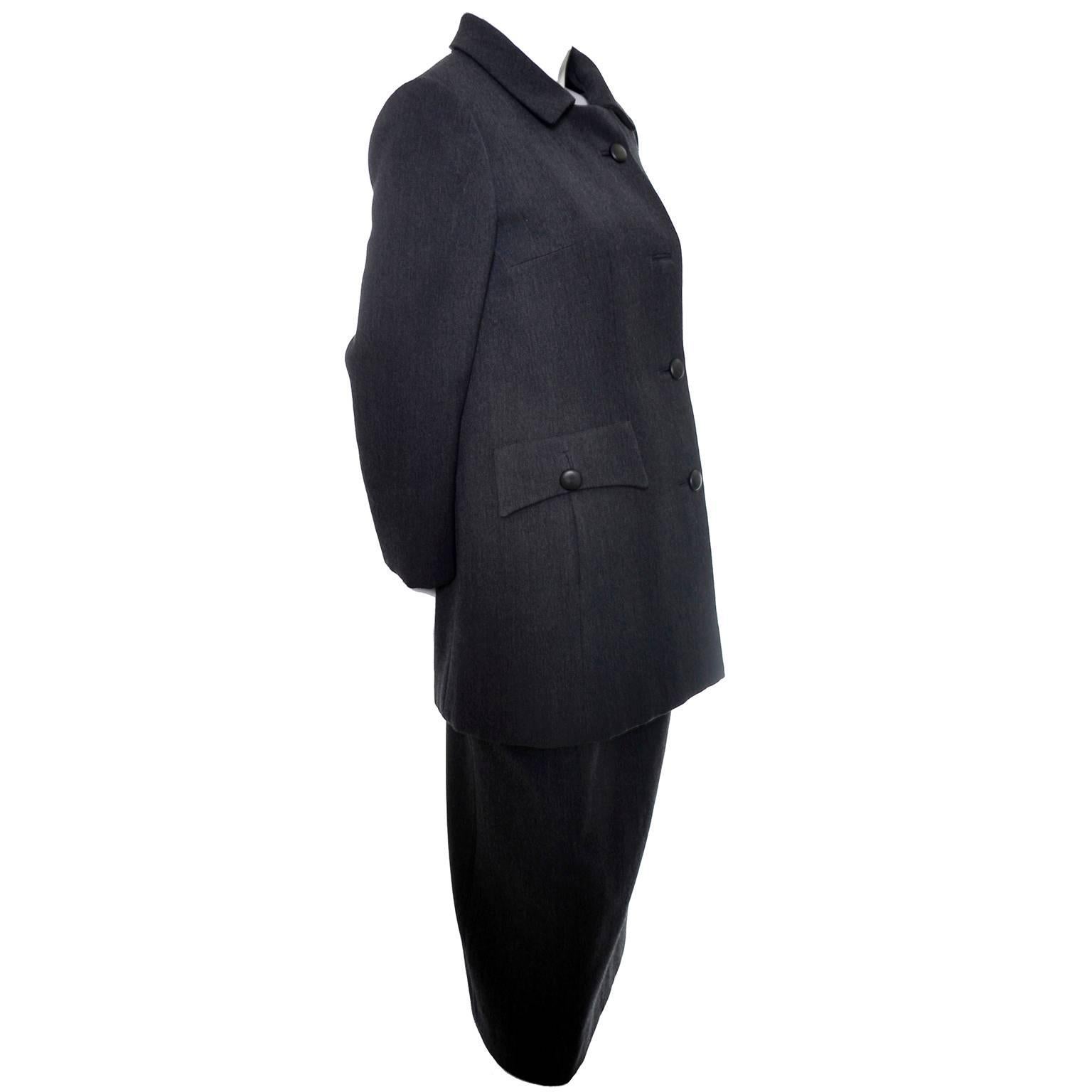 This is a vintage structured wool suit from the early 1960's designed by Harry Shacter for Ben Zuckerman of New York.  The suit is made of dark gray wool and lined in silk.  The skirt has a side zipper and the jacket has front buttons and pockets. 