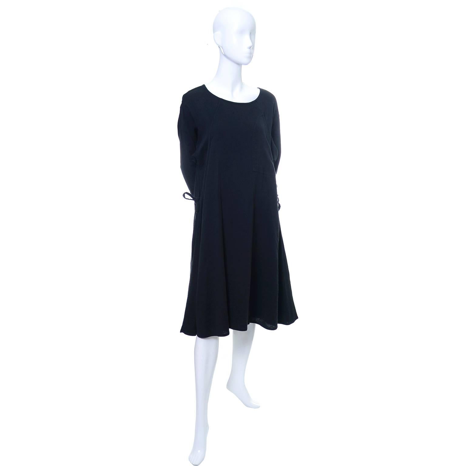 This vintage Issey Miyake Sport black cotton day dress can be worn as a dress or a long tunic.  The dress slips overhead, has side ties and is made in a gauzy black cool cotton. The dress was made in the 1980's in Japan and has the expected very