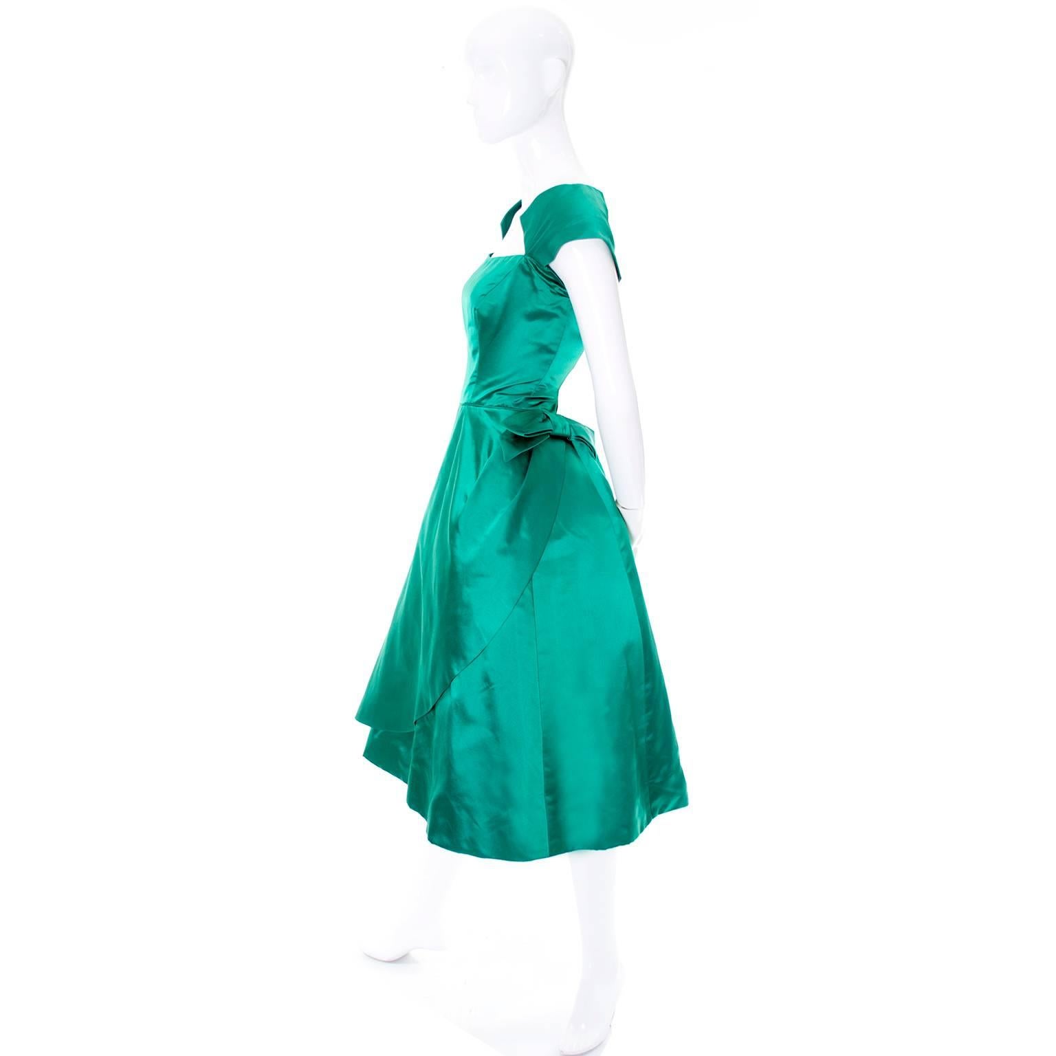This oh so pretty green satin vintage dress was designed by Philip Hulitar in the 1950's.  This dress was purchased at Bramson's Department store in Chicago in the 50's for a special occasion.  The dress has a built in slip and a back zipper (which