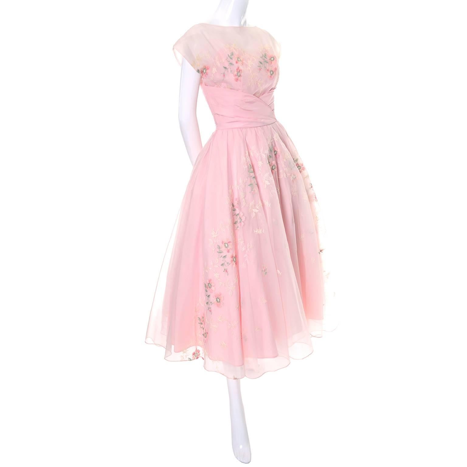 This dreamy vintage dress is in as new condition and was made in the 1950's.  You can twirl on the dance floor for house in this pretty vintage dress.  The dress is pink organza with satin trim and satin lining and it has a back zipper.  There are 2