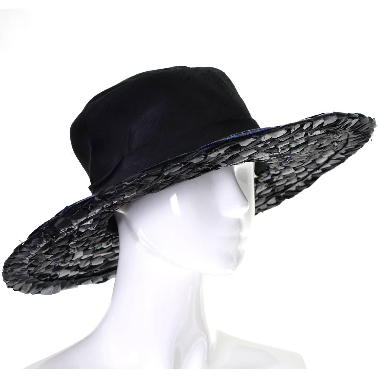 This vintage hat was designed by Elsa Schiaparelli in the 1960's.  The brim of the hat has woven straw in shades of purple, turquoise and black, and the crown is made of black raw silk.  The inside band circumference is 23