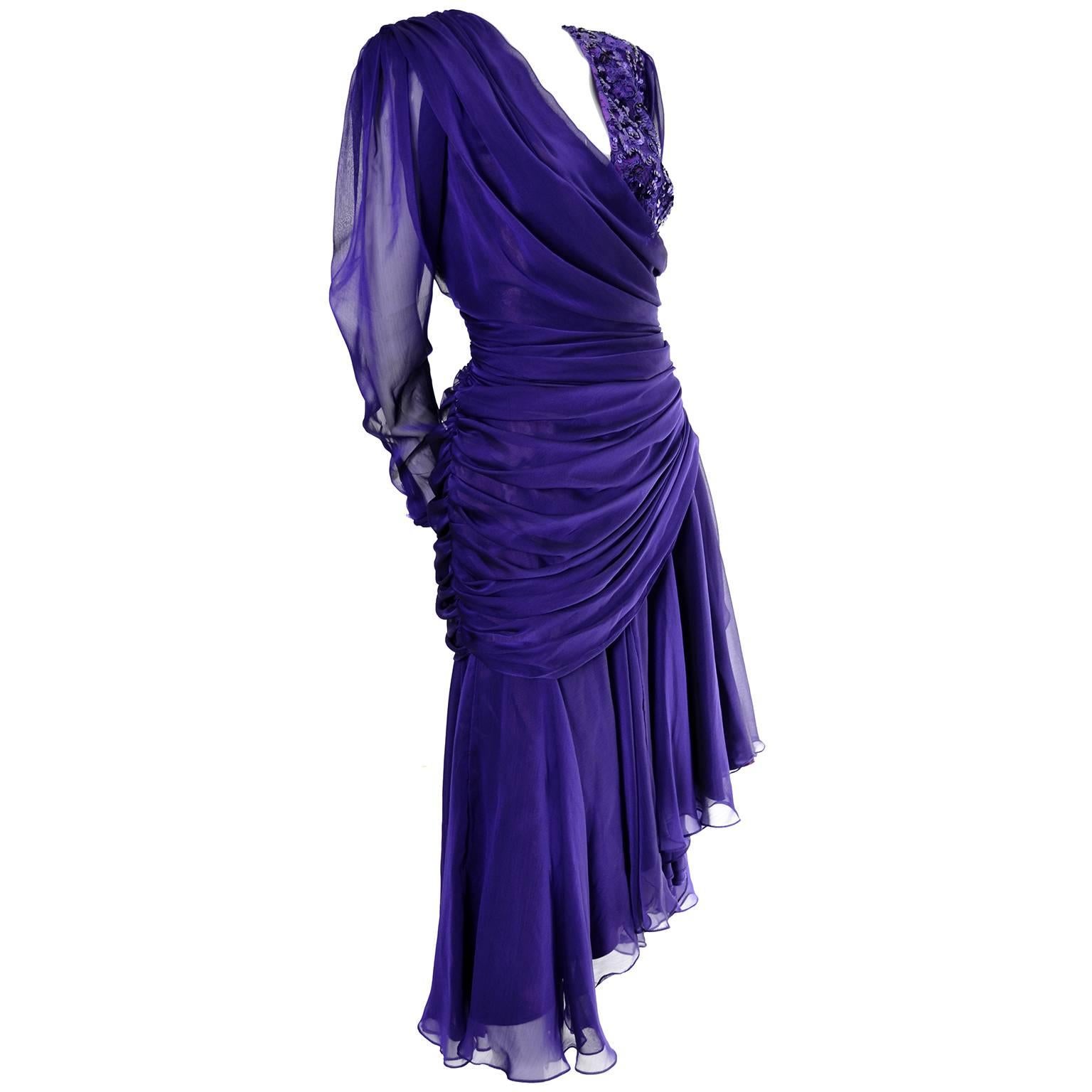 This Tadashi Shoji vintage dress is in a purple poly chiffon and is fully lined.  The bodice is covered on one side with pretty sequins and the sleeves are sheer with tiny purple buttons on the cuffs.  The dress closes with a back zipper and has