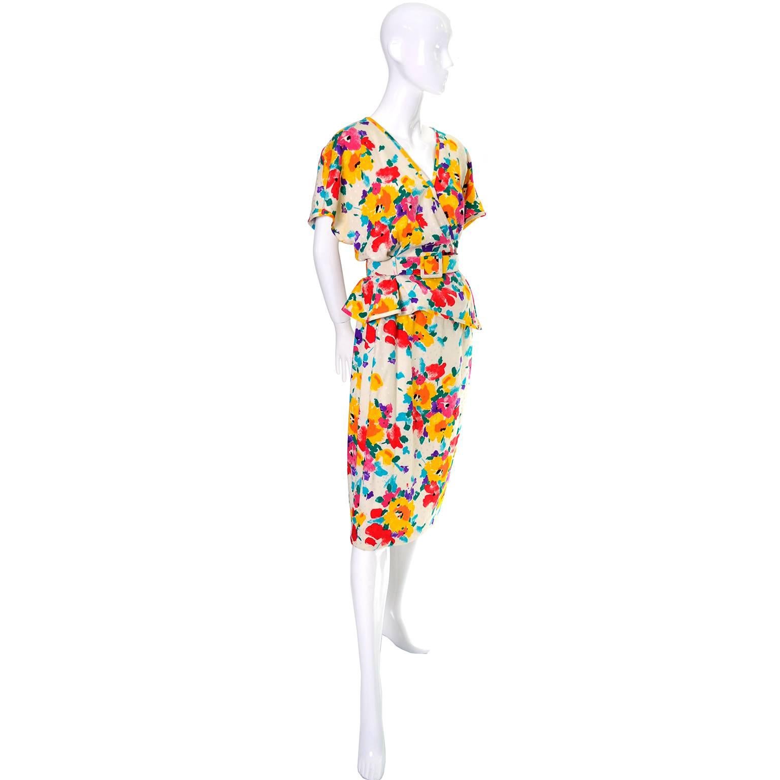This is a fabulous vintage 2 piece silk dress that was designed by Emanuel Ungaro and made in Italy in the 1980's. This pretty, vintage outfit includes a skirt with a side zipper and a matching jacket with an asymmetrical buttoned closure and  a
