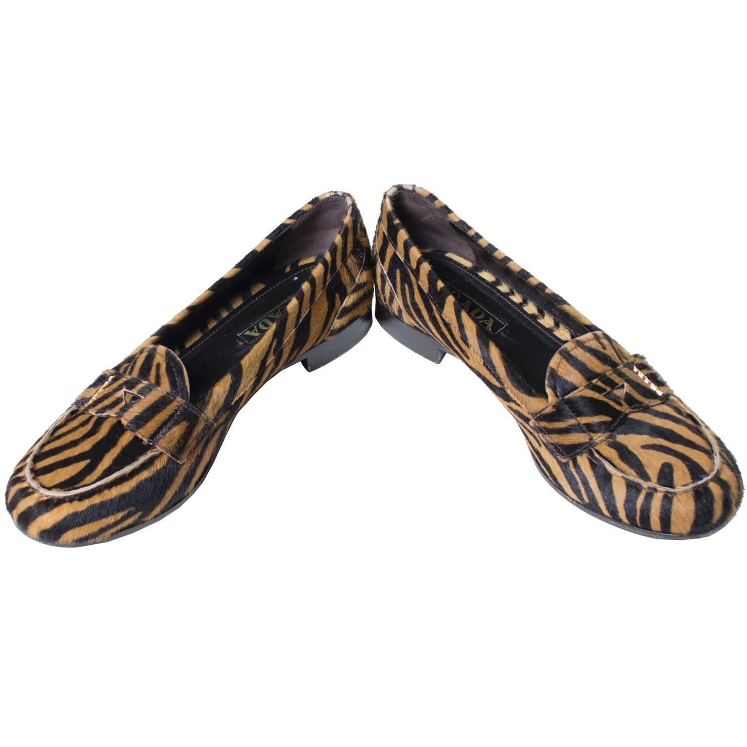 These timeless Prada loafers are in a fab animal print dyed pony or cow fur and only have minor sole scuffs to indicate they have ever been worn.  The shoes have 3/4 inch shoes, measure 3 and 1/8