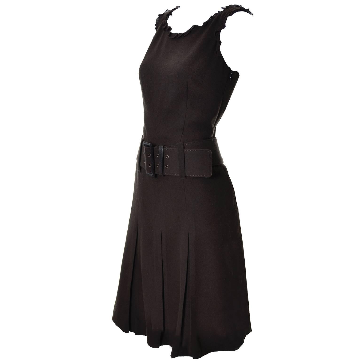 This sleeveless brown wool dress from Moschino Cheap and Chic has a great wide belt and pleated skirt.  The arm holes and neck are trimmed with brown opaque organza ruffle and the dress is fully lined.  You could wear a turtleneck under this dress