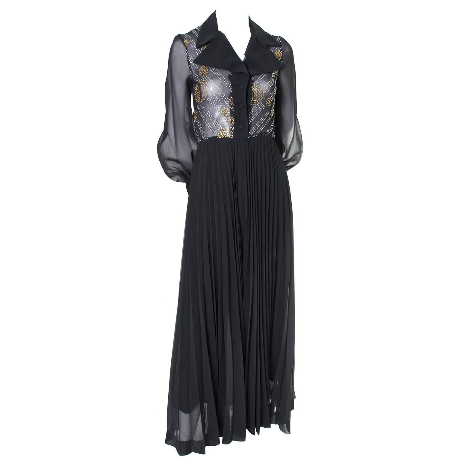 This vintage 1970's maxi dress has incredible style!  The full, long semi sheer skirt is lined with black satin and pleated. The sheer, button front bodice is embellished with gold and silver glitter sparkles and there are lovely bishop sleeves with