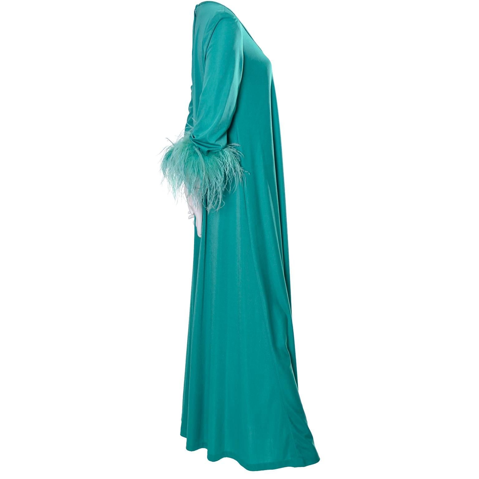 We love these glamorous gowns from Lilli Diamond. This green jersey maxi dress can be worn as a dress or a hostess outfit.  The dress has a low scoop neck, long sleeves with dyed green ostrich feather cuffs and there is a back zipper. I estimate