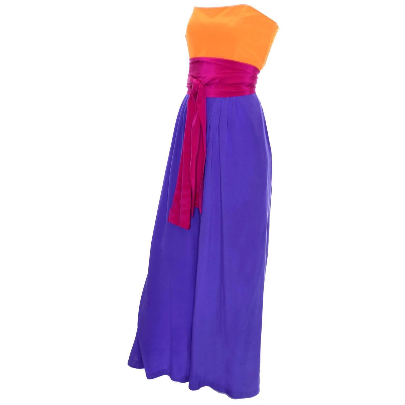 This vintage strapless silk wide leg jumpsuit was designed by Linda Allard for Ellen Tracy and made in Hong Kong in the 1980's. This amazing outfit is in a gorgeous orange and purple color block silk with a deep pink silk sash. This comes with its