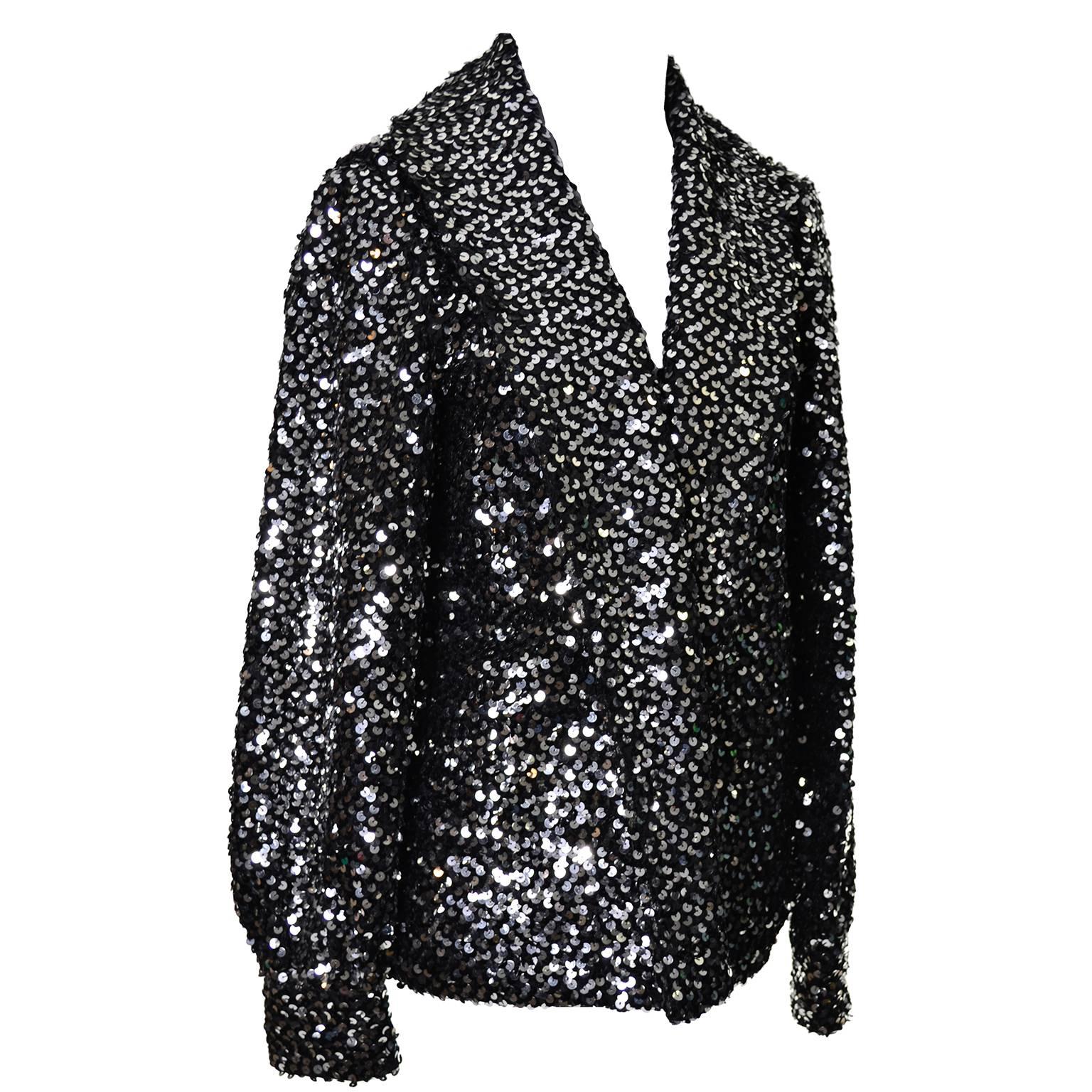 This vintage I Magnin evening jacket is the perfect companion to your cocktail dress during the holidays, or anytime during the year! The cardigan style jacket is quilted and covered in silver and black metallic sequins.  This pretty jacket has