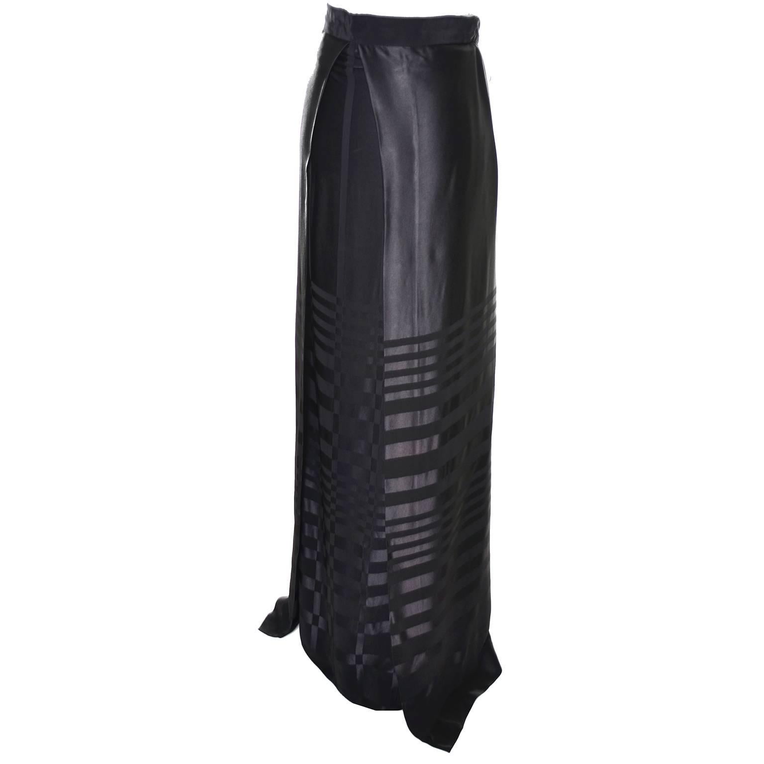 This incredible vintage skirt is from Jean Varon and was designed by John Bates and made in England in the 1970's. This black rayon blend satin tone on tone striped skirt has a slim long skirt underneath an attached over skirt. There is a back