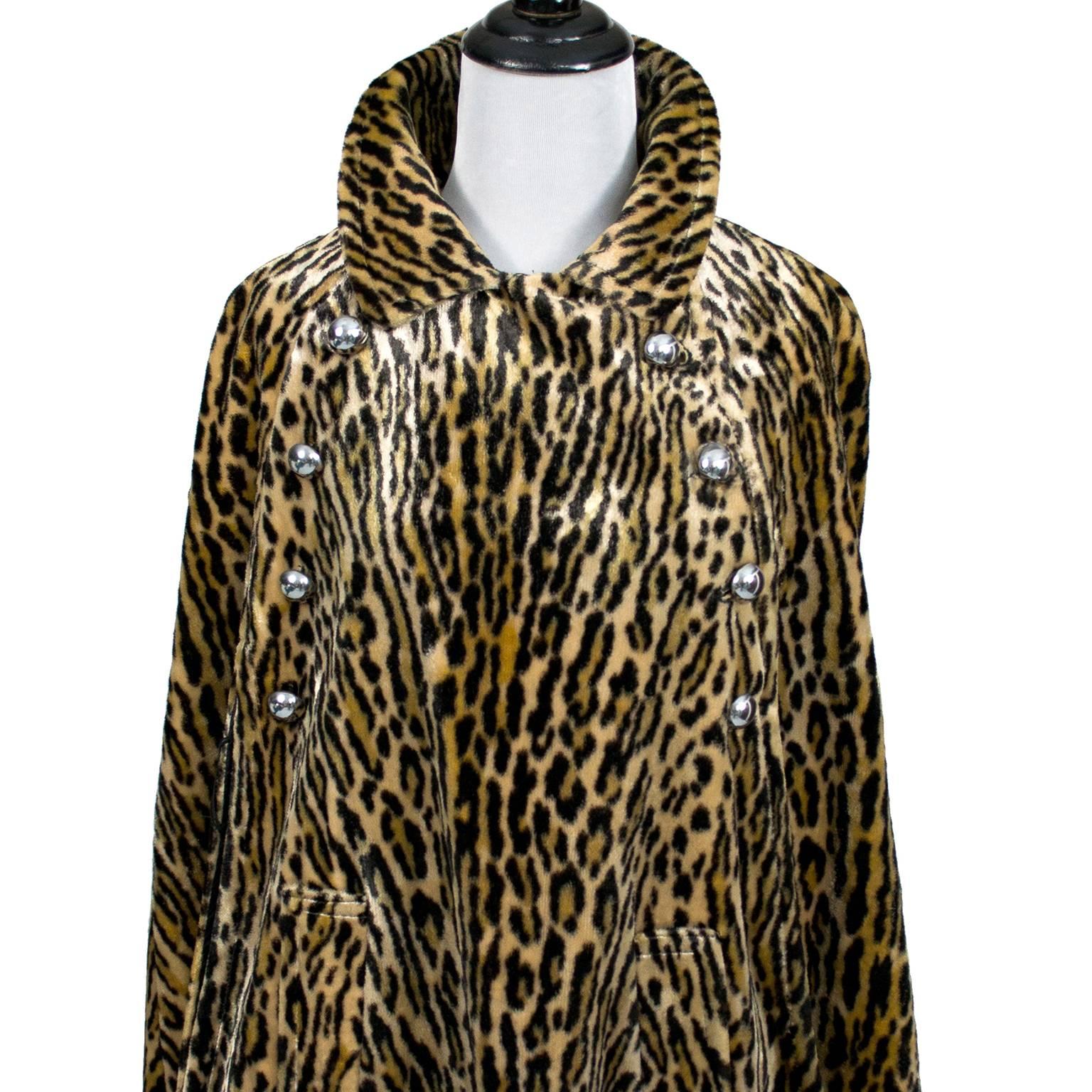 This vintage cape was purchased in the 1960's and is fully lined in brown satin.  The cape is made in a faux fur leopard animal print and has a label that reads:  Harolde's. This cape has big silver domed buttons and side slit pockets. This fits