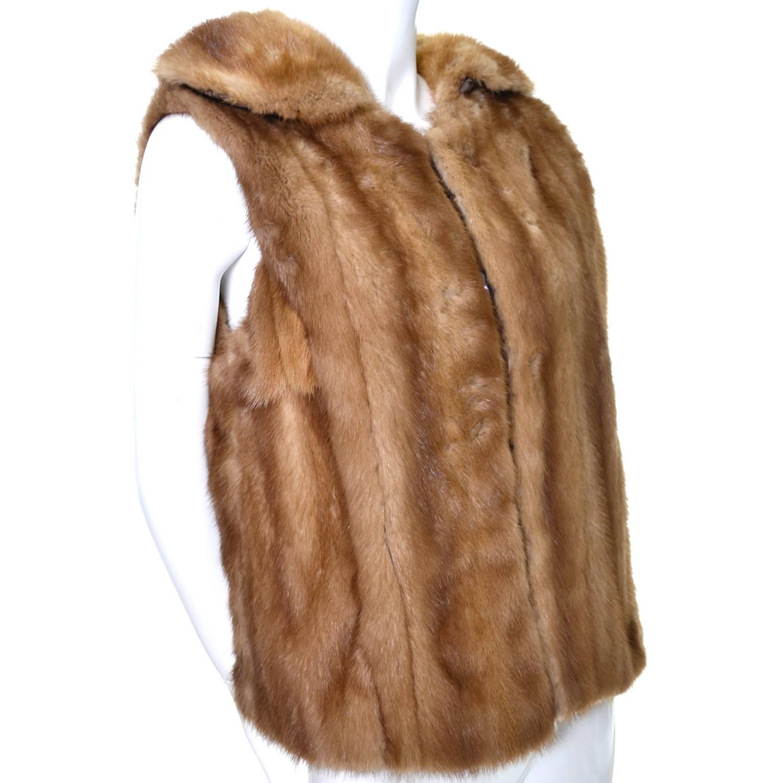 This vintage mink vest would be great with a pair of jeans, leggings, or even with a skirt. This fur vest is fully lined in satin and has two front hook and eyes for closure.  I would say it is a size M/L depending on how you like to wear your