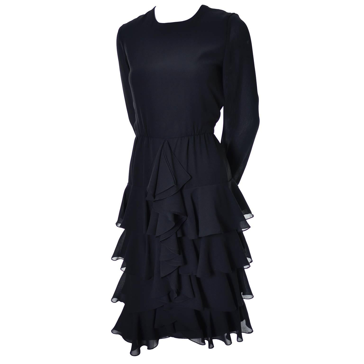 This is a great vintage dress from designer Bill Blass. The dress is layered with ruffled black chiffon crepe and it zips up the back. The long sleeves have ruffled cuffs and though the content label has been removed, the dress has the Bill Blass