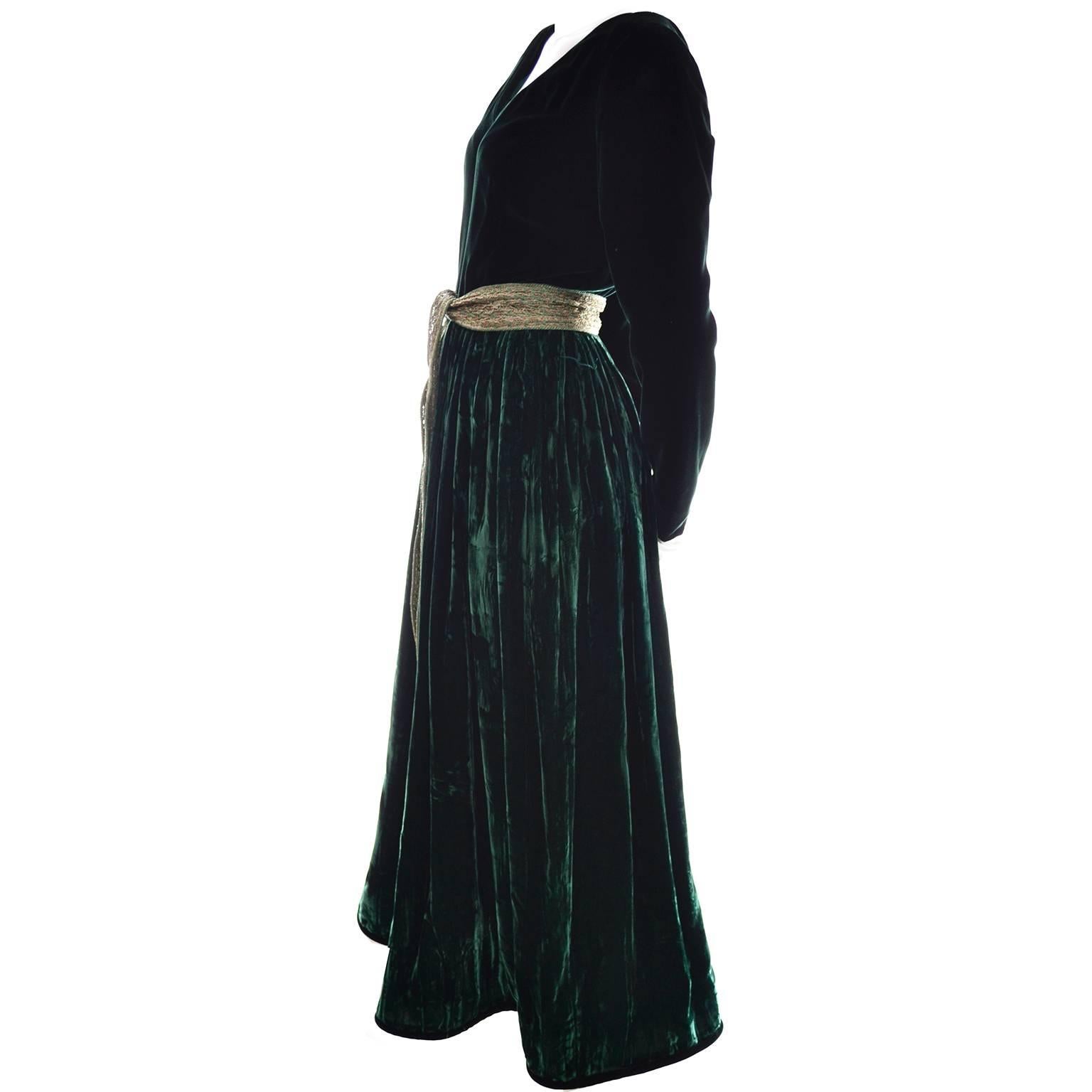 This luxurious green velvet evening gown was designed by Oscar de la Renta and has the Oscar de la Renta Studio label.  The bodice is smooth deep green velvet and the skirt is satin backed crushed green velvet with deep green trim at the hem line. 