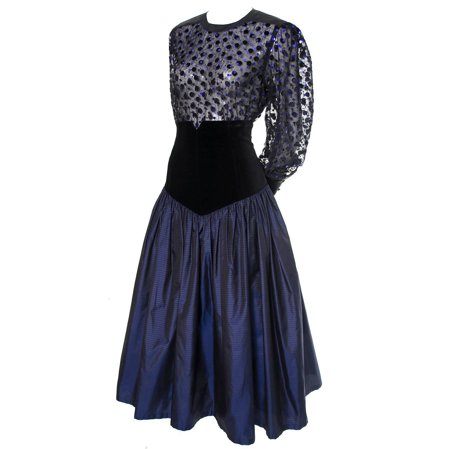 This vintage Escada 1980's evening ensemble is so stunning! This beautiful 2 piece evening dress was designed by Margaretha Ley.  The skirt is an iridescent blue with fine vertical black stripes and the waist is all black velvet.  There is a back