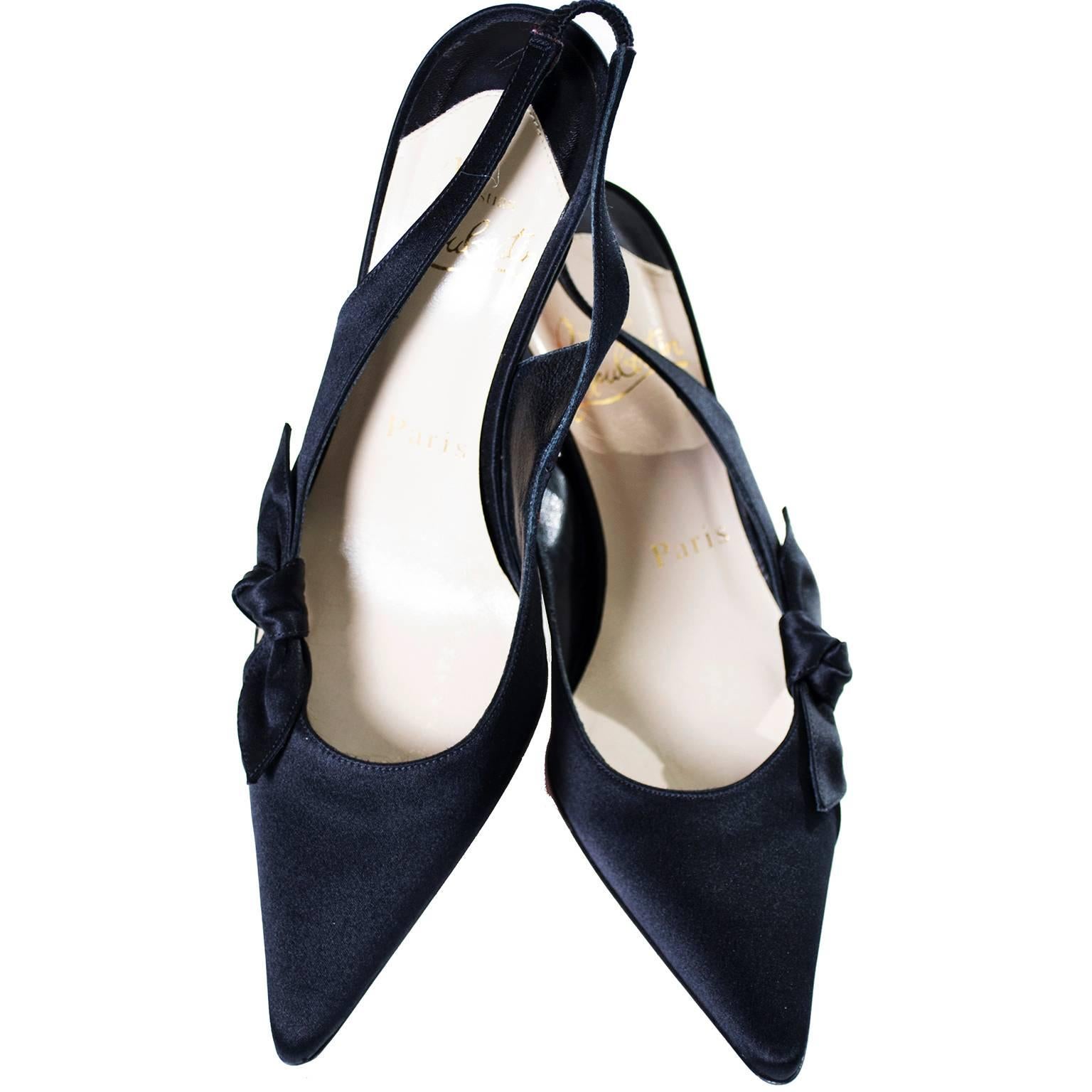 These are lovely black satin Christian Louboutin Paris sling backs with pretty side bows. These gorgeous shoes are labeled a European size 35.5 (US size 5.5), and have only very minor sole scuffs, and are otherwise in excellent.  The heels are 3 and