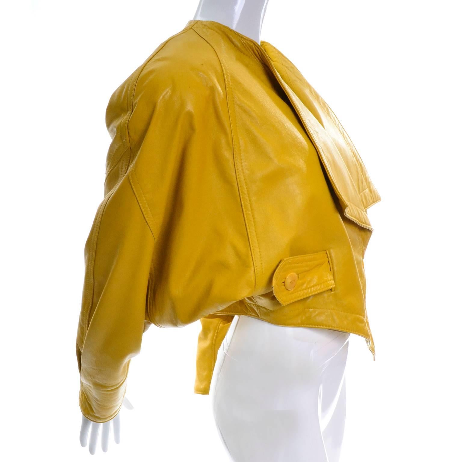 This is a show stopping mustard yellow vintage jacket designed by Rocco D'Amelio for Giovinezza Moda in the 1980's.  The jacket has dolman sleeves, shoulder pads and an asymmetrical front closure with a snap and a button that closes with a small