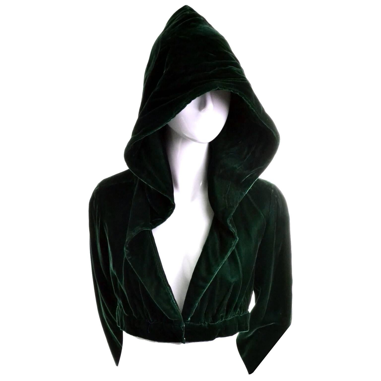 This is one of our favorite little cropped jackets at Dressing Vintage.  This luxe green velvet bolero has a hood and is fully lined.  The jacket closes in the front with two snaps and has a shawl collar and long sleeves.  This is such a great piece