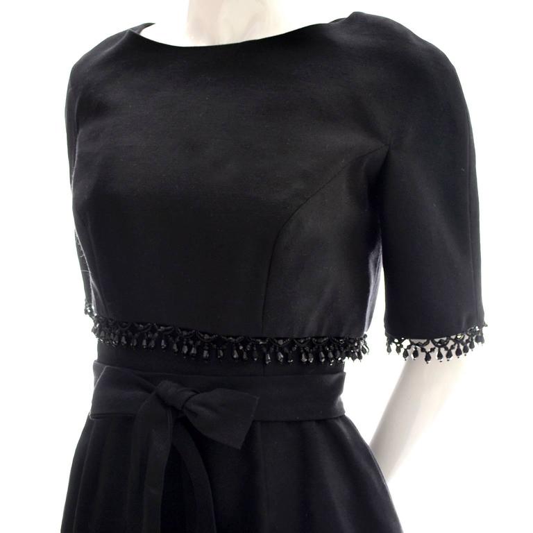 I love this 1960's vintage dress from Edward Abbott. The dress itself is sleeveless with a low back with a back zipper with a bow at the cinched waist.  The cropped bolero style jacket that buttons in the back is beaded with beautiful black glass