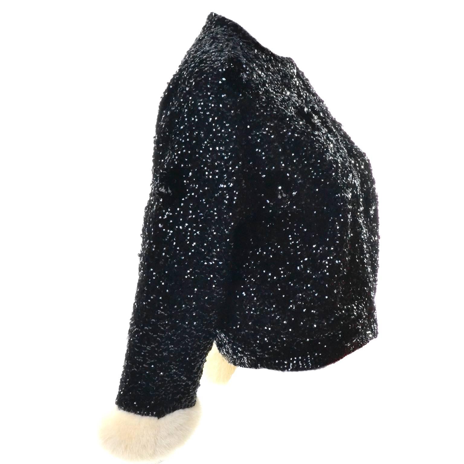 This is an absolutely exquisite little black cashmere or wool/cashmere blend jacket that has incredible white mink cuffs and is covered in black sequins. These beaded and sequin sweaters or jackets were common in the 1960's but this one is special
