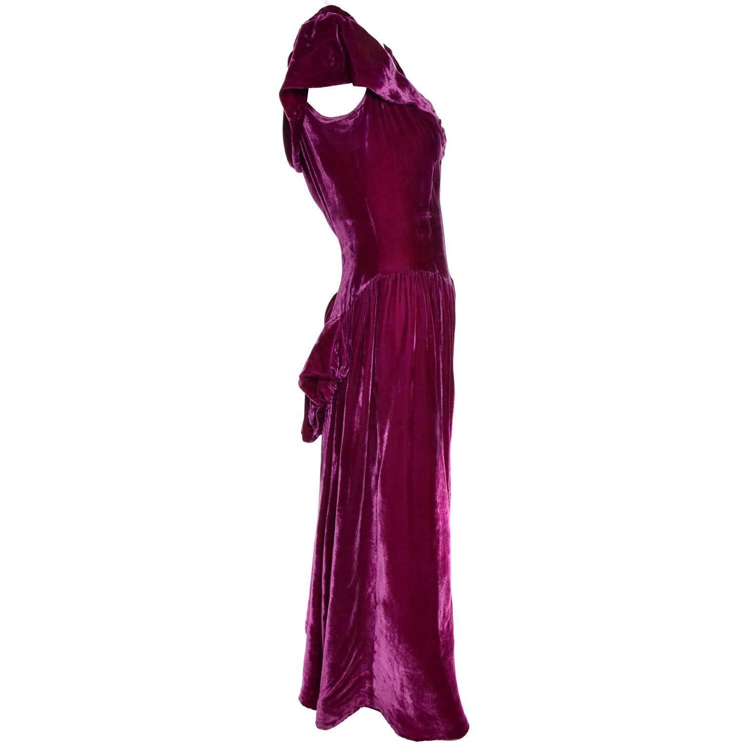 This late 1930's vintage dress is made from a luxe deep raspberry rayon velvet and has a back "bustle" and semi off shoulder sleeves with elastic for a slight gather..  This beautiful vintage dress has a side metal zipper and is in