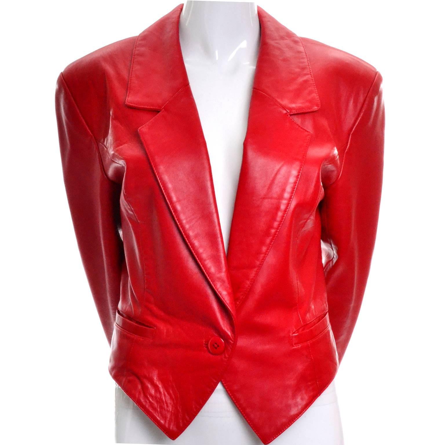 This soft, supple leather vintage jacket was designed by Michael Hoban for North Beach Leather in the 1980's.  This cherry red leather cropped tuxedo style jacket has front pockets and closes with a single button. The jacket is in excellent