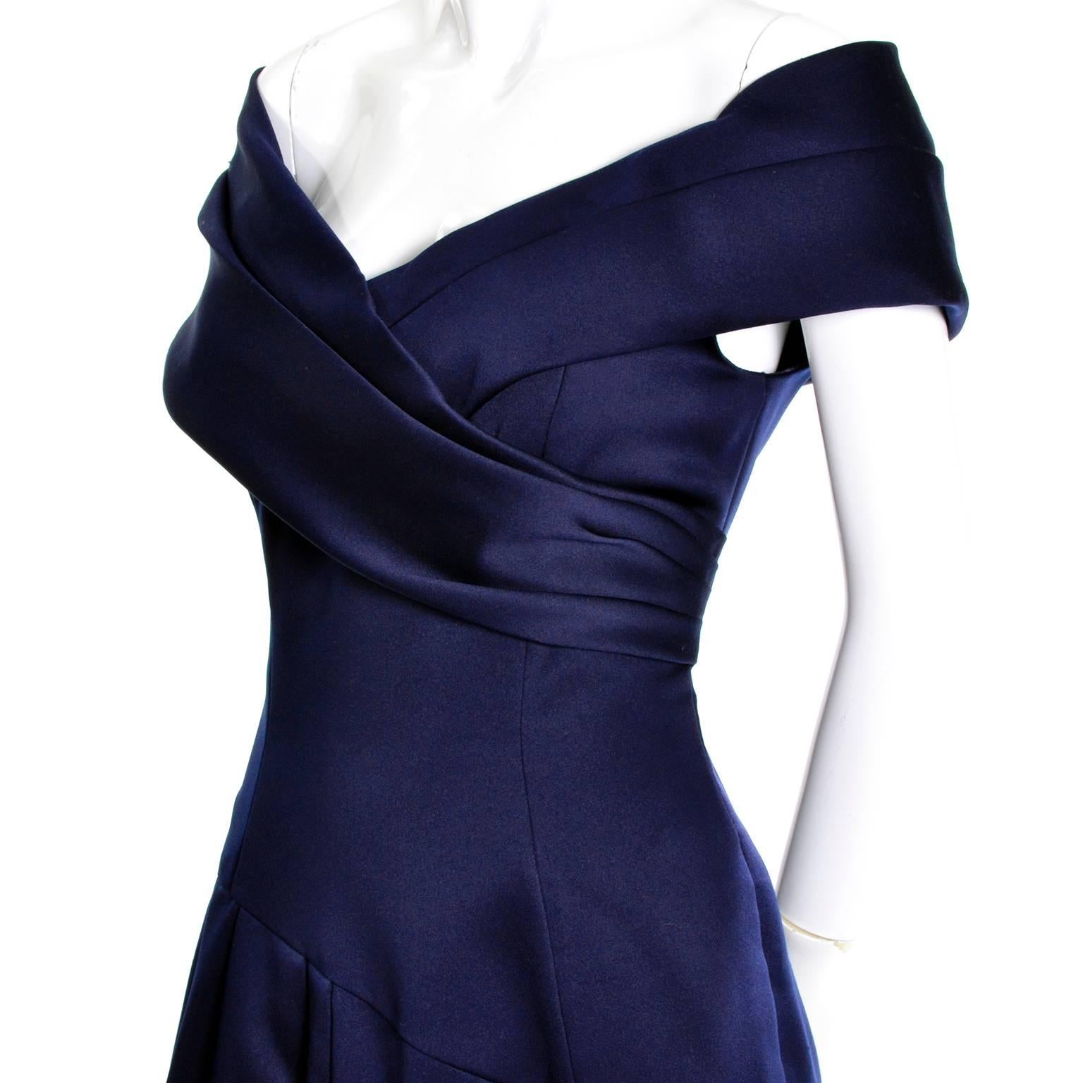 This vintage navy blue evening gown was designed by Victor Costa. The dress is matte satin  in excellent condition and the skirt portion is lined with tulle.  There are optional shoulder straps that we haven't shown or you can wear the dress